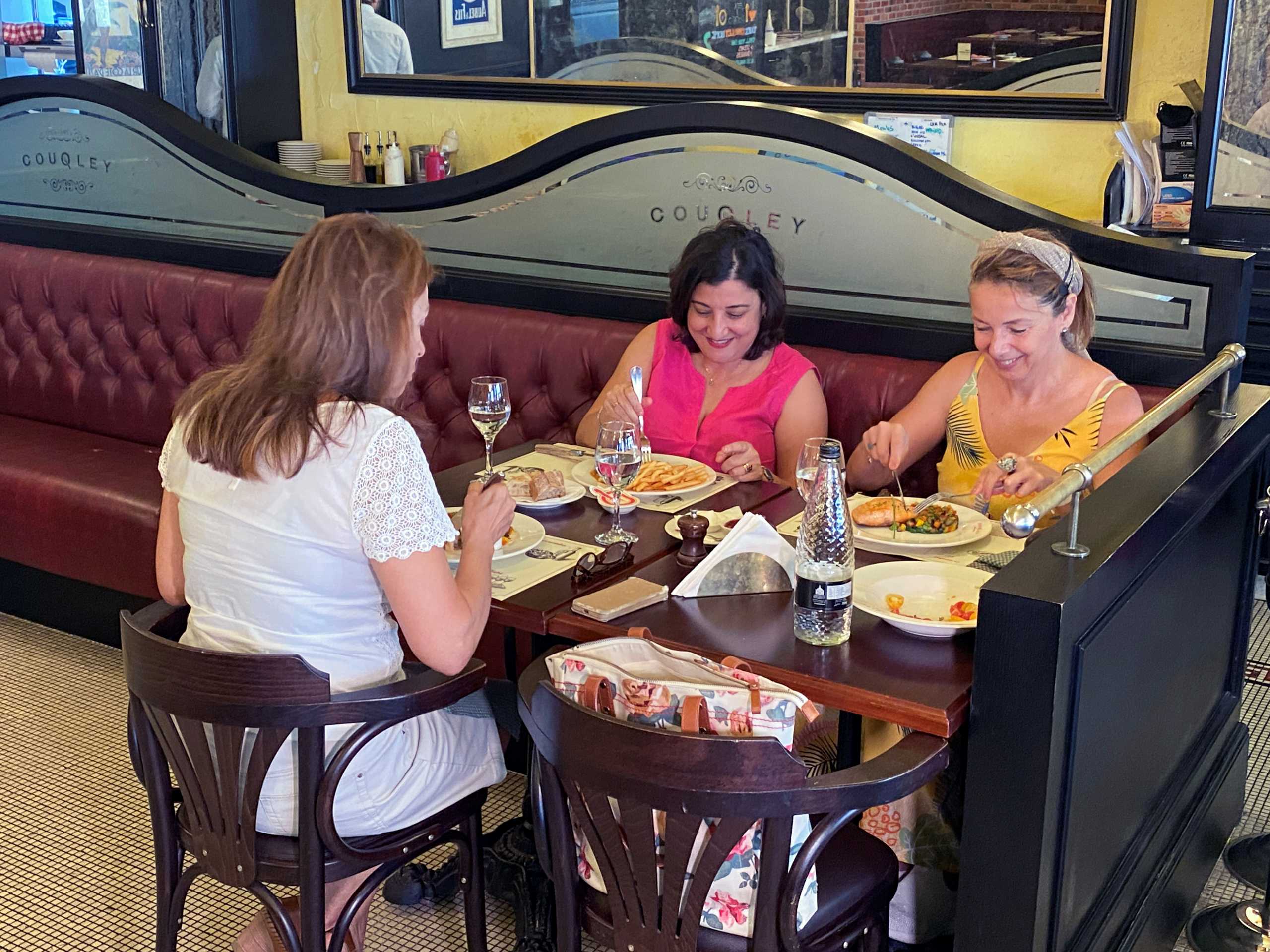 People sit in a restaurant after Dubai has for the first time allowed restaurants to operate freely during fasting hours of Ramadan in Dubai, United Arab Emirates May 2, 2021. Picture taken May 2, 2021. REUTERS