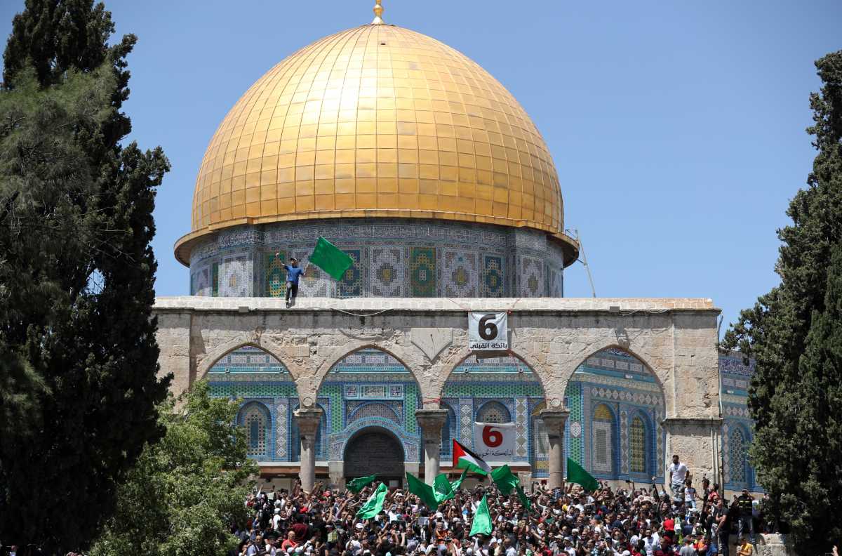 Palestinians gather in front of the Dome of the Rock, after performing the last Friday of Ramadan, to protest over the possible eviction of several Palestinian families from homes on land claimed by Jewish settlers in the Sheikh Jarrah neighbourhood, in Jerusalem's Old City, May 7, 2021. REUTERS