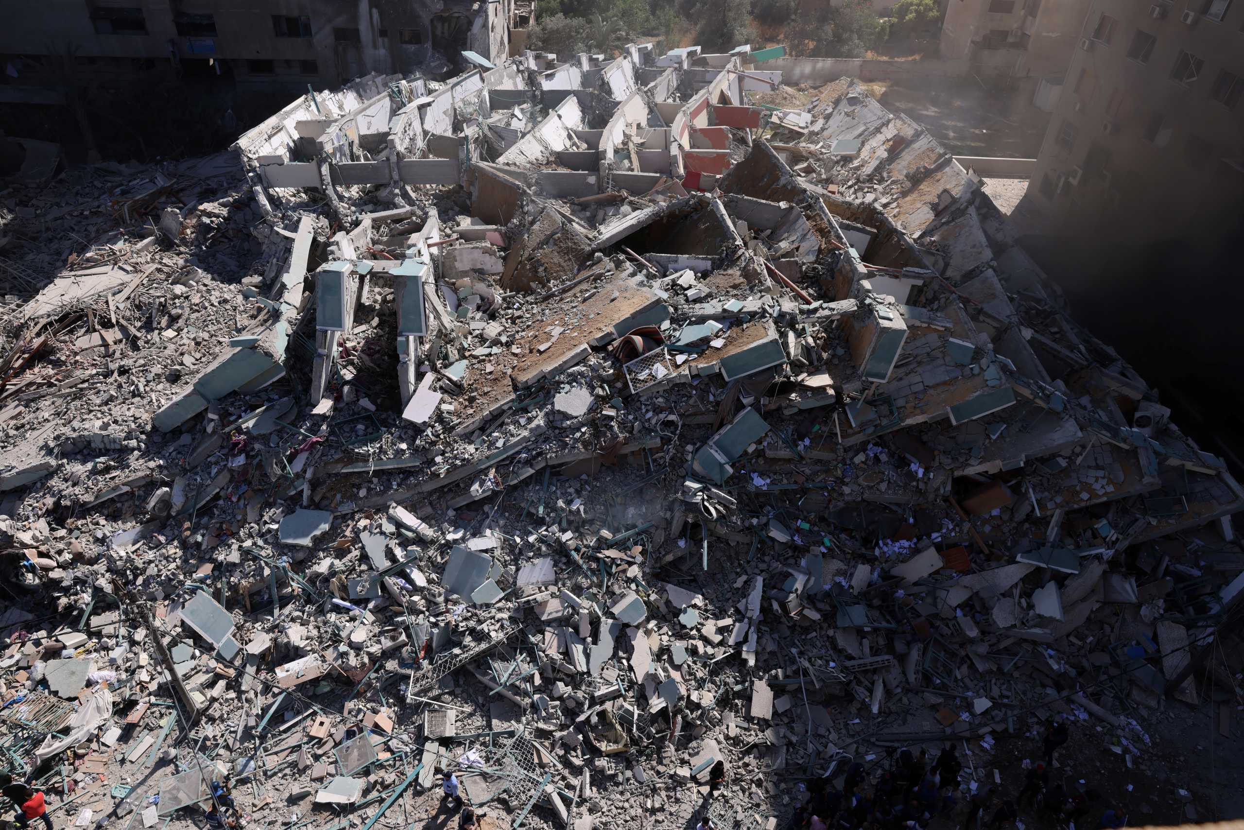 A tower housing AP, Al Jazeera offices collapses after Israeli missile strikes in Gaza city, May 15, 2021. REUTERS