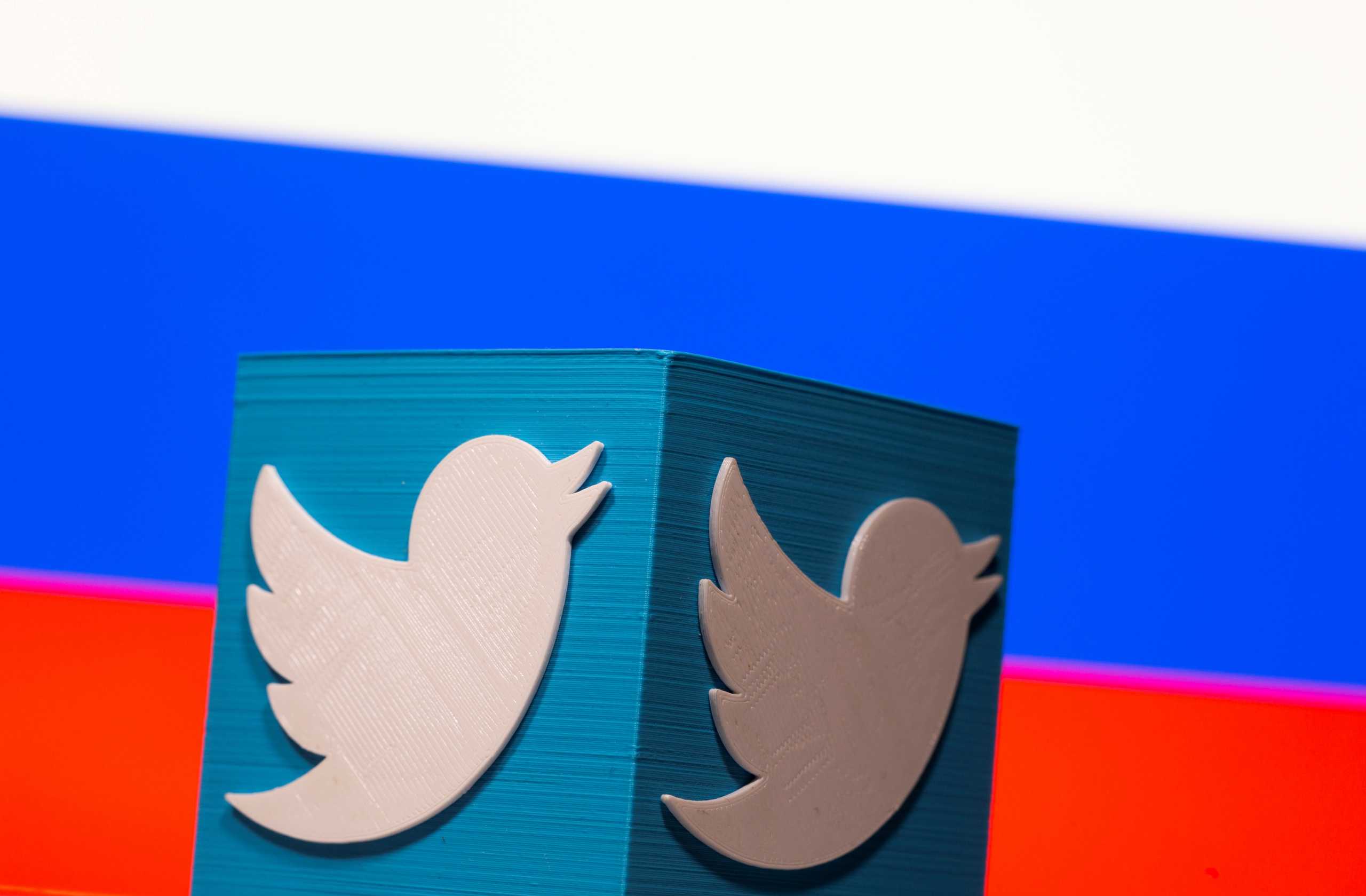 FILE PHOTO: A 3D-printed Twitter logo is pictured in front of a displayed Russian flag in this illustration taken March 10, 2021. REUTERS