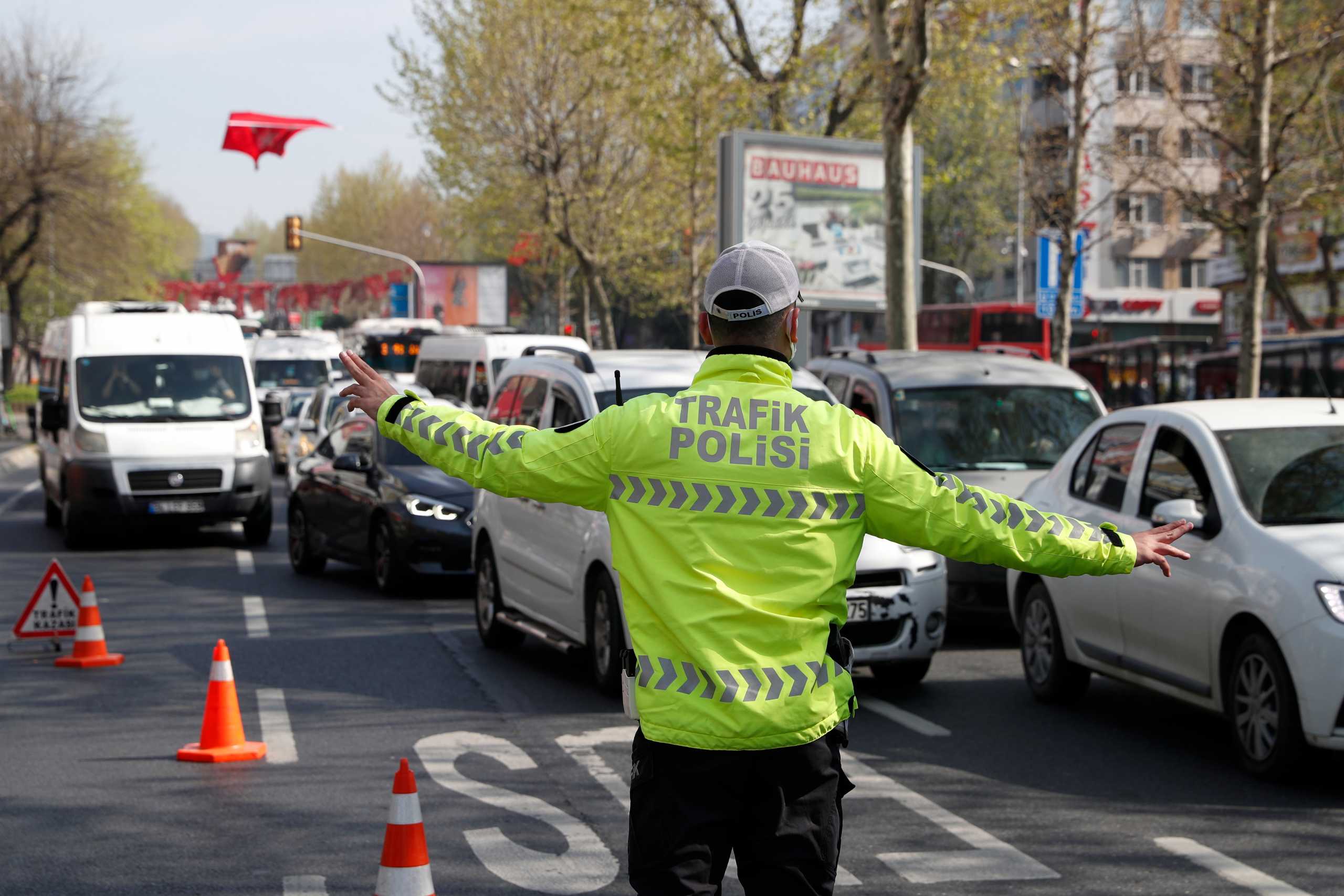 A police officer stops vehicles to check their documents during a nationwide "full closure" imposed to slow the rate of the coronavirus disease (COVID-19) contagion in Istanbul, Turkey April 30, 2021. REUTERS
