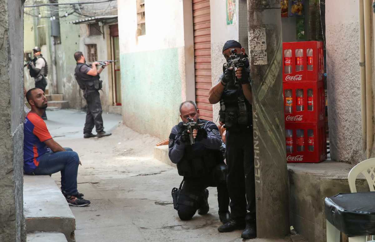 Policemen aim their weapons during an operation against drug dealers in Jacarezinho slum in Rio de Janeiro, Brazil May 6, 2021. REUTERS