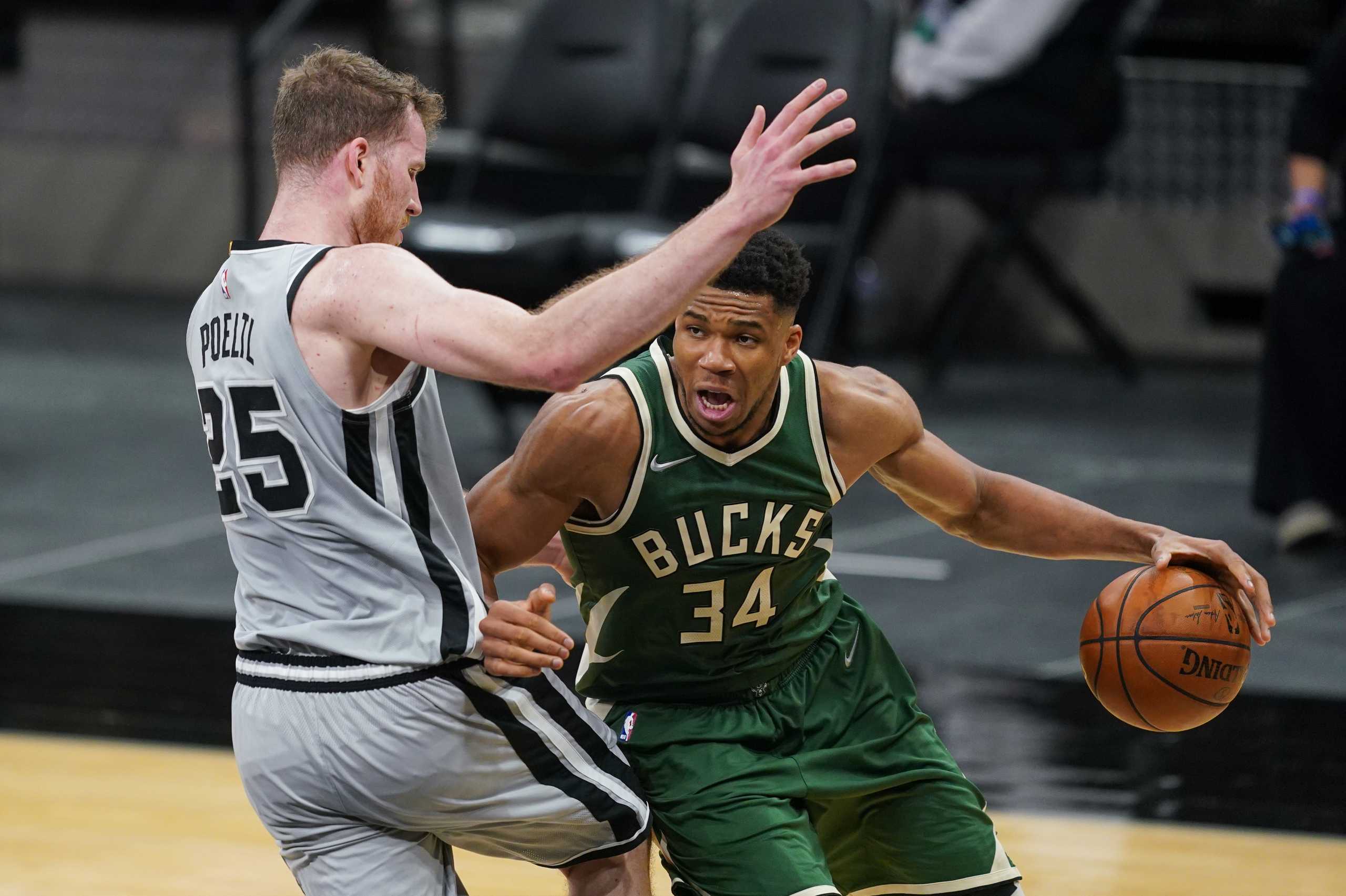 May 10, 2021; San Antonio, Texas, USA; Milwaukee Bucks forward Giannis Antetokounmpo (34) drives against San Antonio Spurs center Jakob Poeltl (25) in the first half at the AT&T Center. Mandatory Credit: Daniel Dunn-USA TODAY Sports