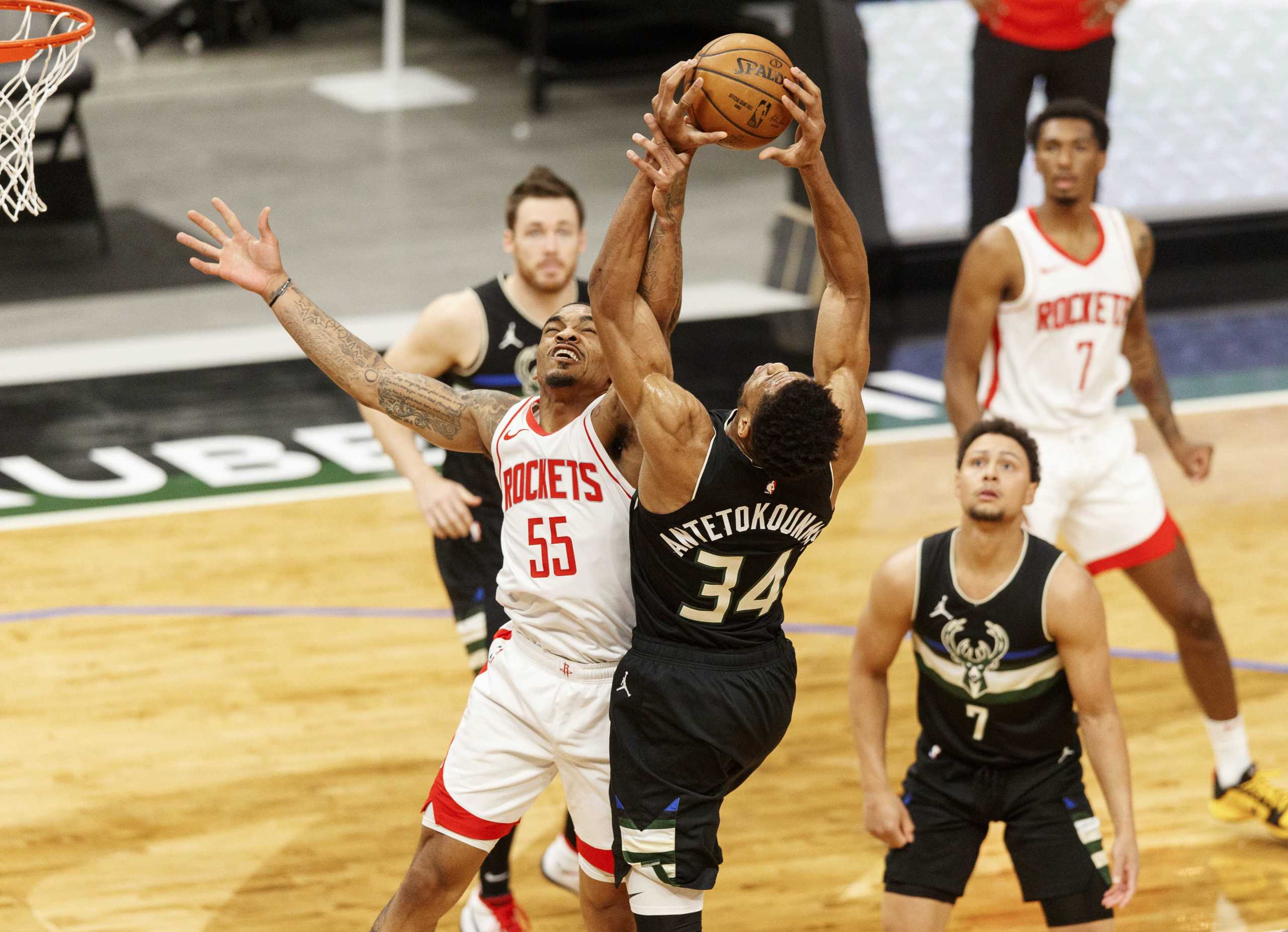 May 7, 2021; Milwaukee, Wisconsin, USA; Houston Rockets guard DaQuan Jeffries (55) and Milwaukee Bucks forward Giannis Antetokounmpo (34) reach for a rebound during the first quarter at Fiserv Forum. Mandatory Credit: Jeff Hanisch-USA TODAY Sports
