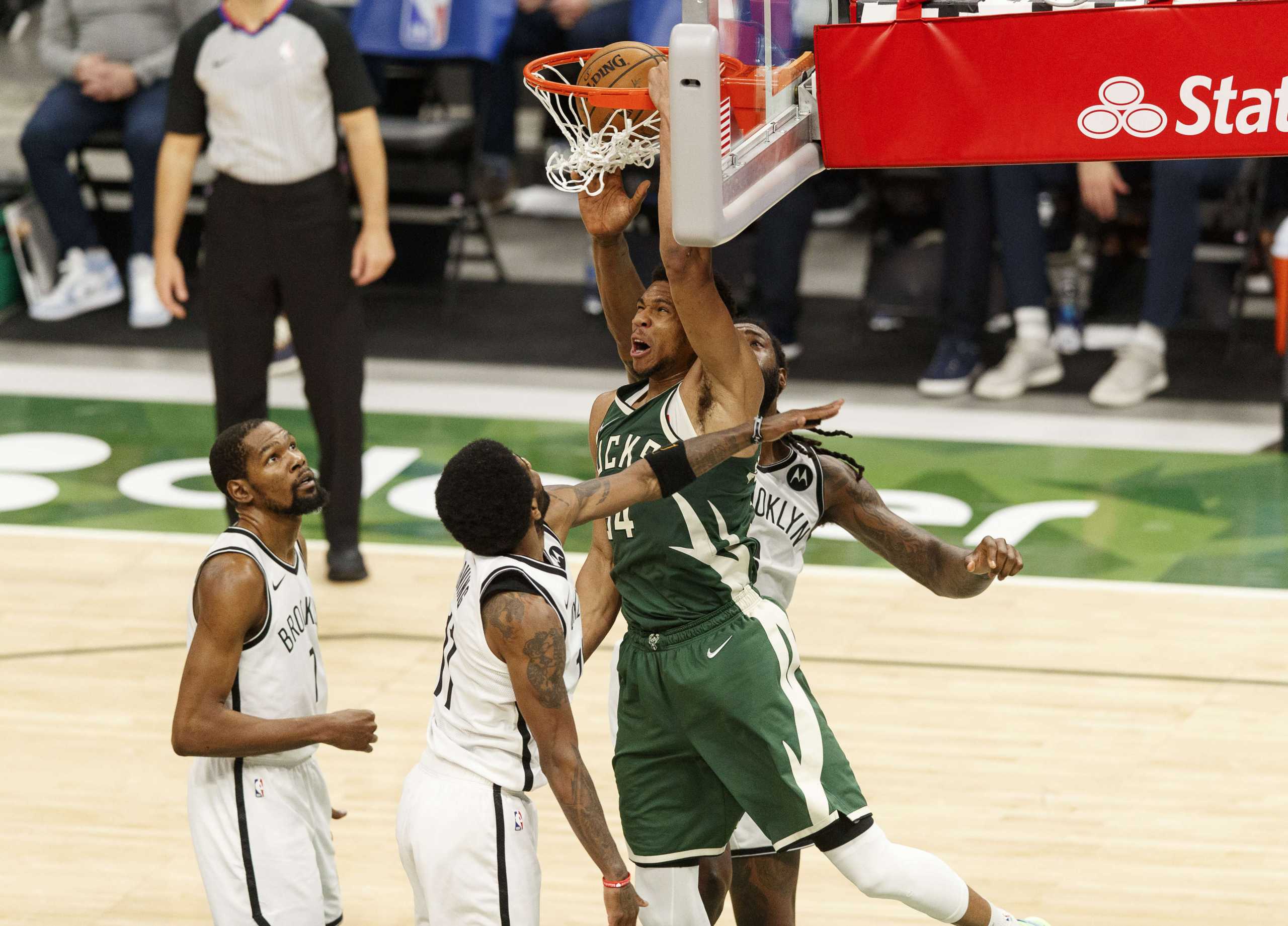 May 2, 2021; Milwaukee, Wisconsin, USA; Milwaukee Bucks forward Giannis Antetokounmpo (34) dunks against Brooklyn Nets guard Kyrie Irving (11) during the second quarter at Fiserv Forum. Mandatory Credit: Jeff Hanisch-USA TODAY Sports