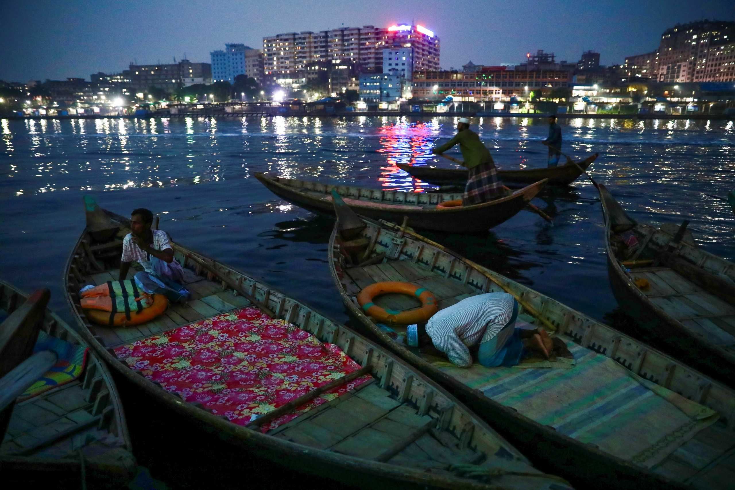 A Muslim boatman performs evening prayer in the holy fasting month of Ramadan at the Buriganga river, in Dhaka, Bangladesh, May 1, 2021. REUTERS