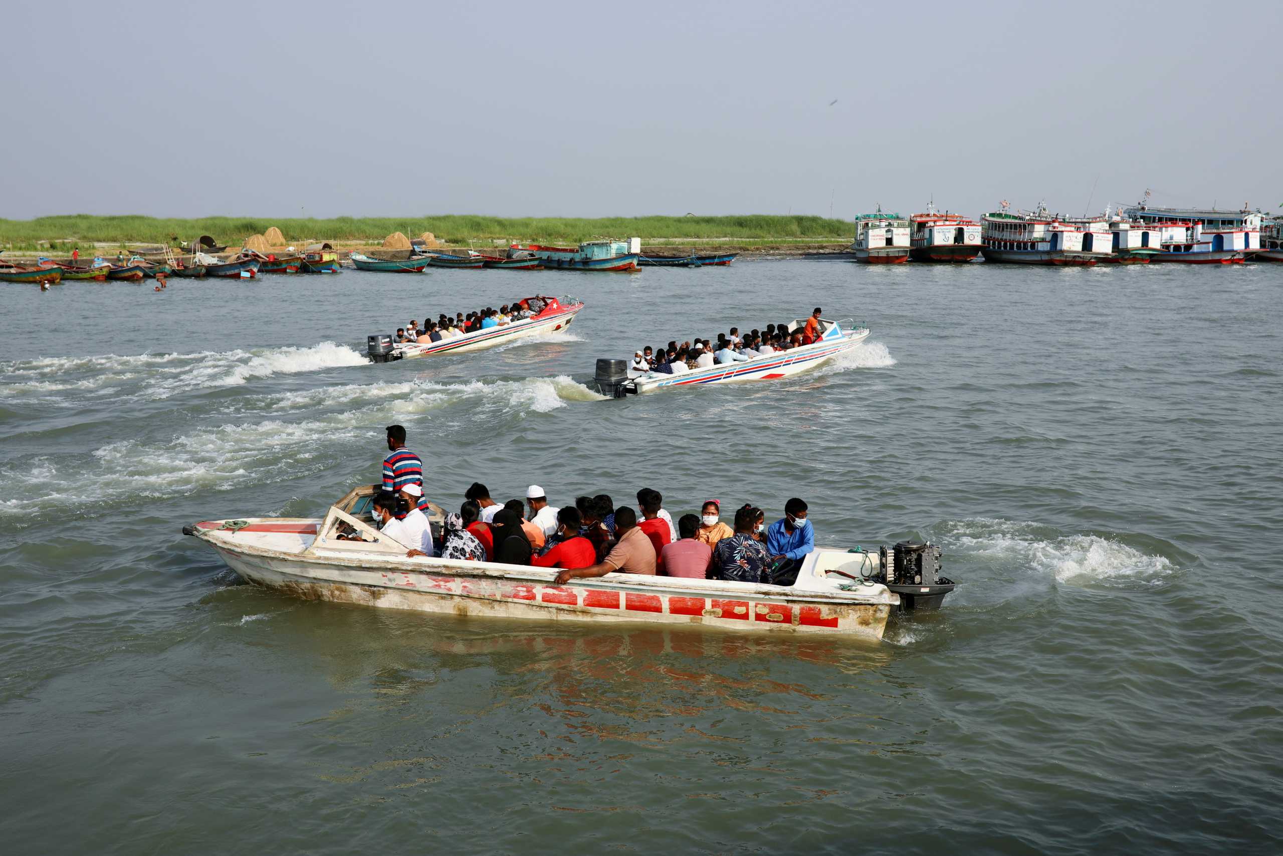 Migrant people and workers travel in speedboats as they leave the city before the countrywide lockdown imposed as the coronavirus disease (COVID-19) cases increased, at Mawa ferry port in Munshiganj, Bangladesh, April 13, 2021. REUTERS