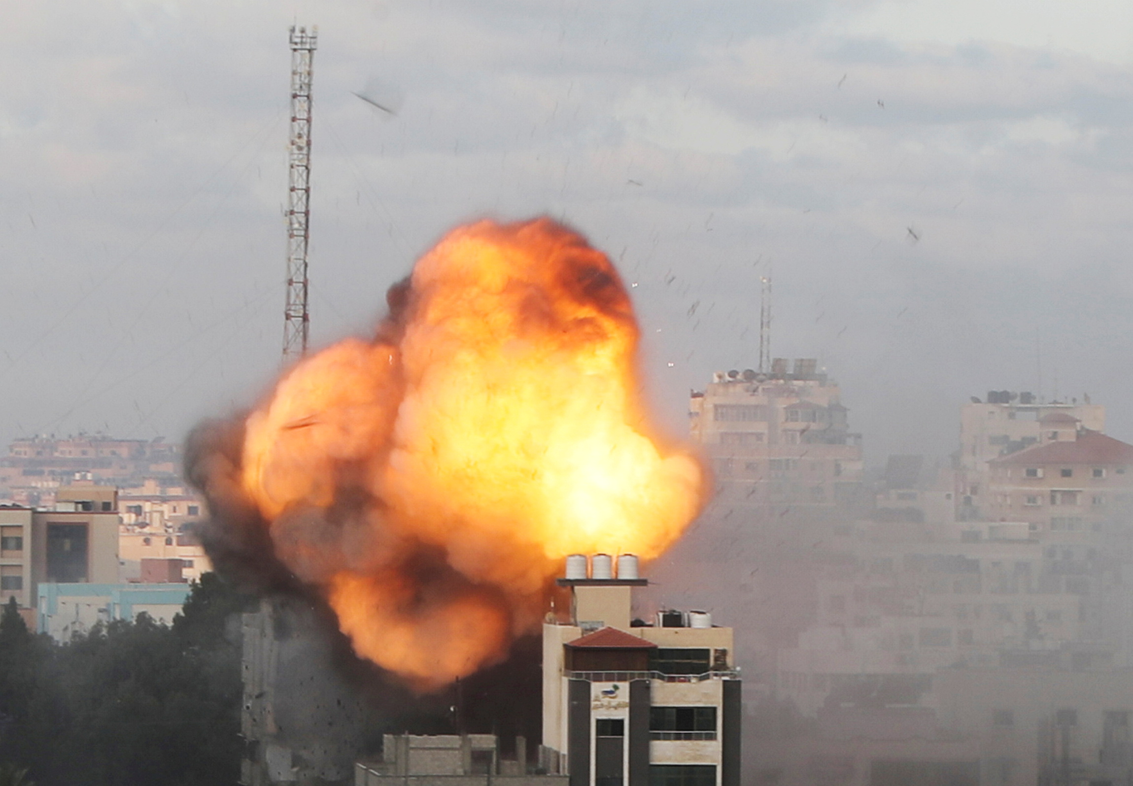 Smoke and flames are seen following an Israeli air strike on a building, amid a flare-up of Israeli-Palestinian fighting, in Gaza City May 18, 2021. REUTERS