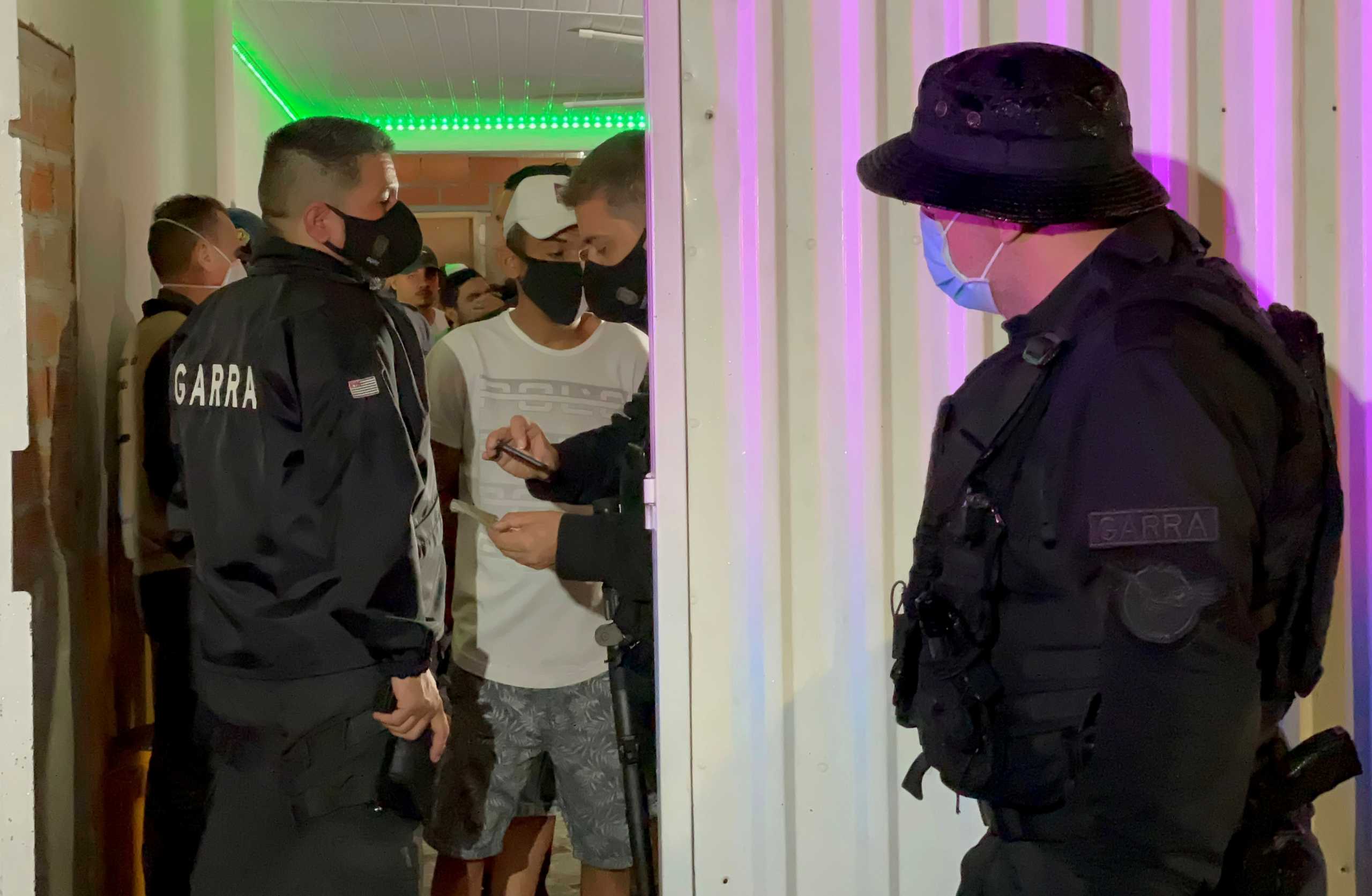 A police officer checks the ID of a man during a civil police operation tackling COVID-19 restriction violations, amid a rise in coronavirus disease cases and deaths, in Sao Paulo, Brazil April 18, 2021. Picture taken April 18, 2021. REUTERS