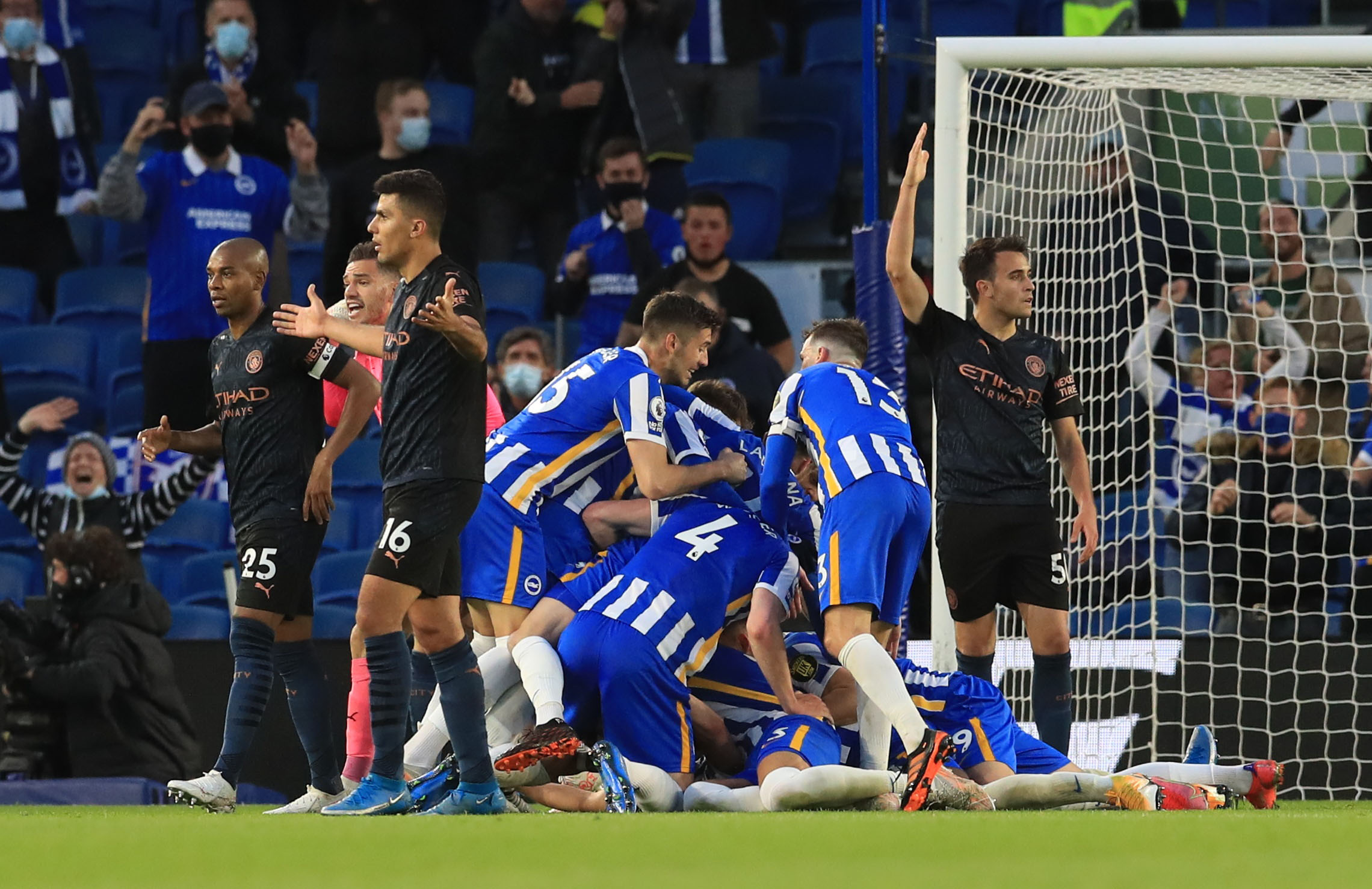 Soccer Football - Premier League -  Brighton & Hove Albion v Manchester City - The American Express Community Stadium, Brighton, Britain - May 18, 2021 Brighton & Hove Albion's Dan Burn celebrates scoring their third goal with teammates Pool via REUTERS