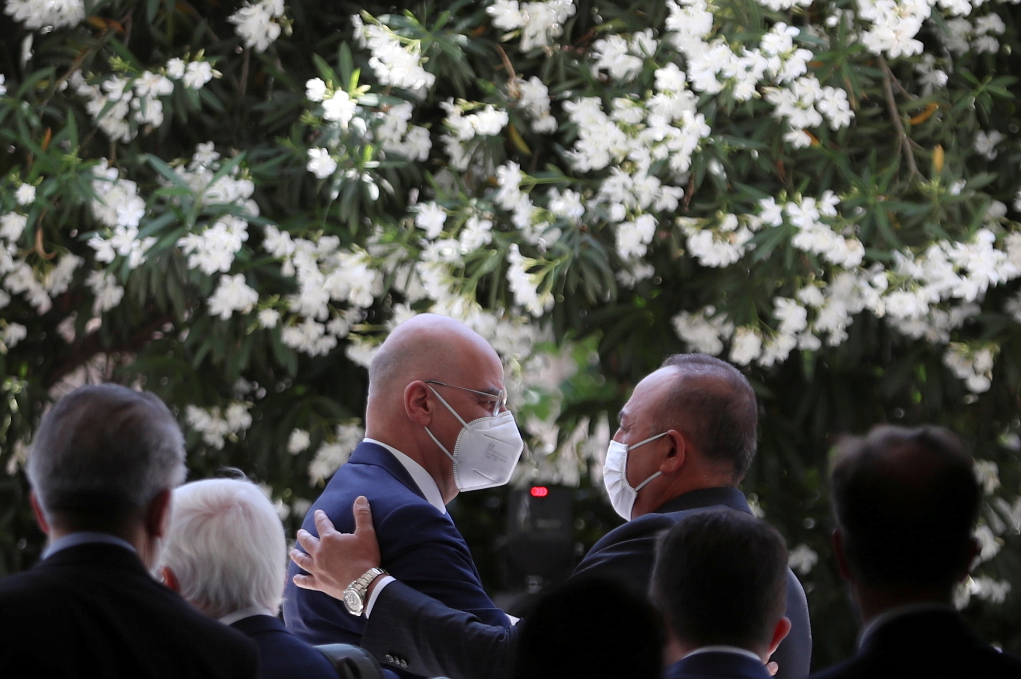 Greek Foreign Minister Nikos Dendias and his Turkish counterpart Mevlut Cavusoglu greet each other after a news conference at the Ministry of Foreign Affairs in Athens, Greece, May 31, 2021. REUTERS