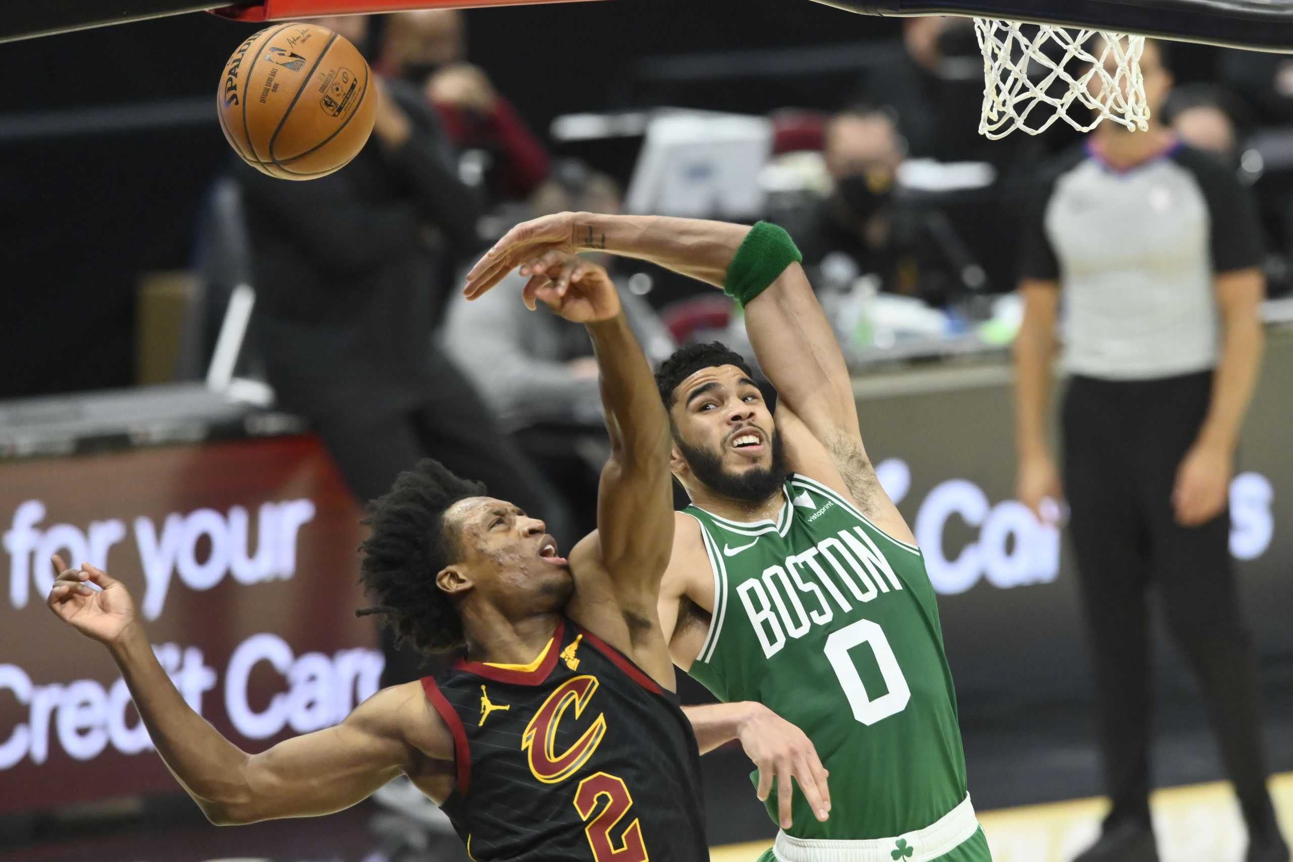 May 12, 2021; Cleveland, Ohio, USA; Boston Celtics forward Jayson Tatum (0) defends a shot by Cleveland Cavaliers guard Collin Sexton (2) in the third quarter at Rocket Mortgage FieldHouse. Mandatory Credit: David Richard-USA TODAY Sports