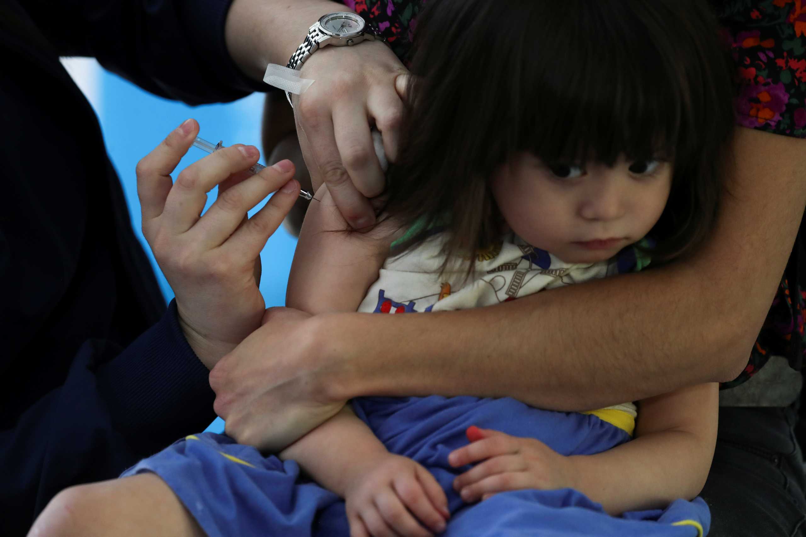 A child receives a vaccine as part of the seasonal flu vaccination campaign for children and elderly people, during the coronavirus disease (COVID-19) pandemic, in Santiago, Chile April 13, 2021. REUTERS