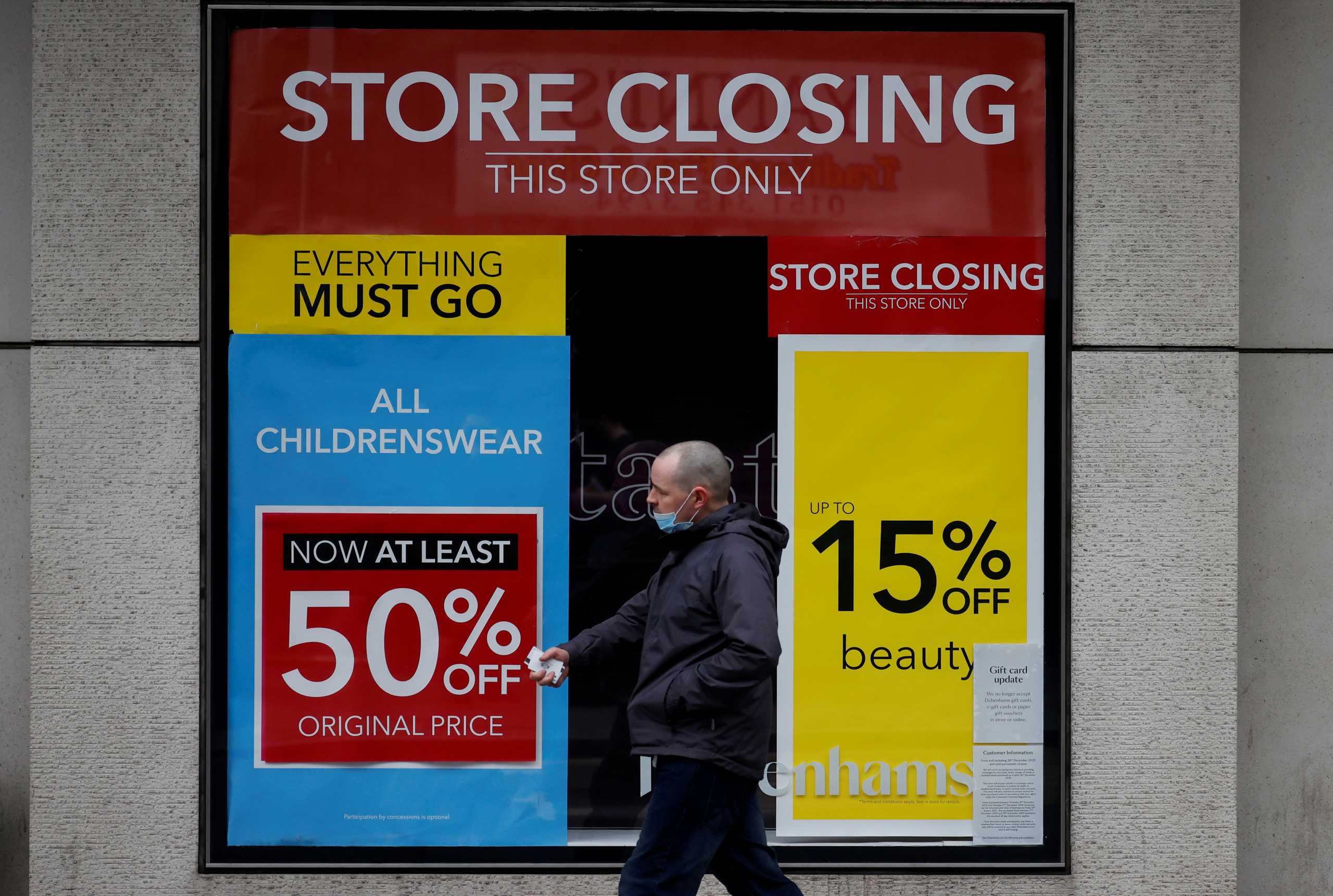 FILE PHOTO: A man walks past a closed branch of Debenhams amid the outbreak of the coronavirus disease (COVID-19) in Liverpool, Britain, February 23, 2021. REUTERS