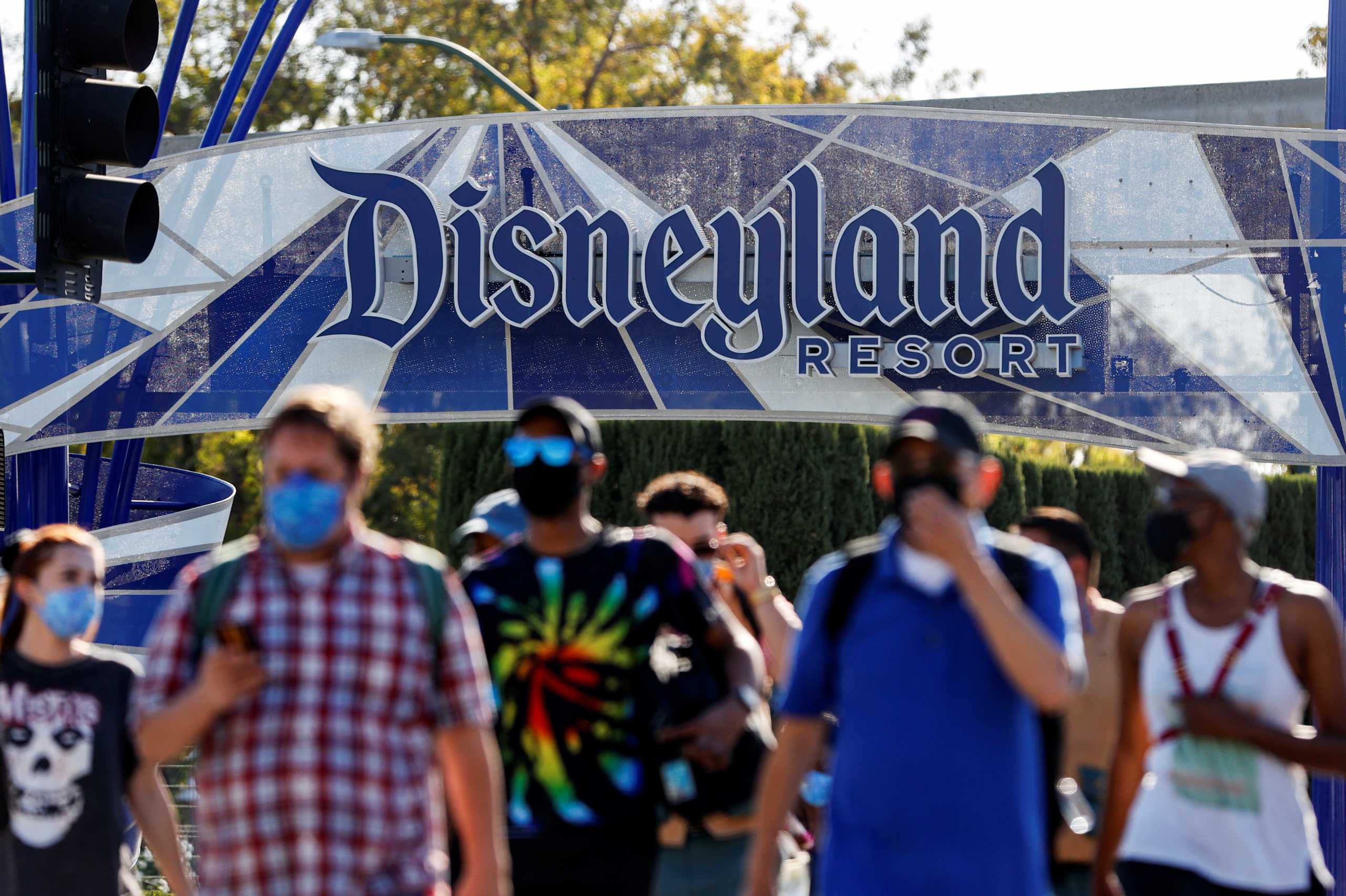People leave the Disneyland Resort on Disneyland Park and Disney California Adventure's reopening day amidst the coronavirus disease (COVID-19) outbreak, in Anaheim, California, U.S., April 30, 2021.  REUTERS