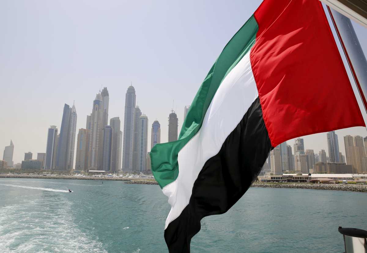 FILE PHOTO: UAE flag flies over a boat at Dubai Marina, Dubai, United Arab Emirates May 22, 2015. REUTERS