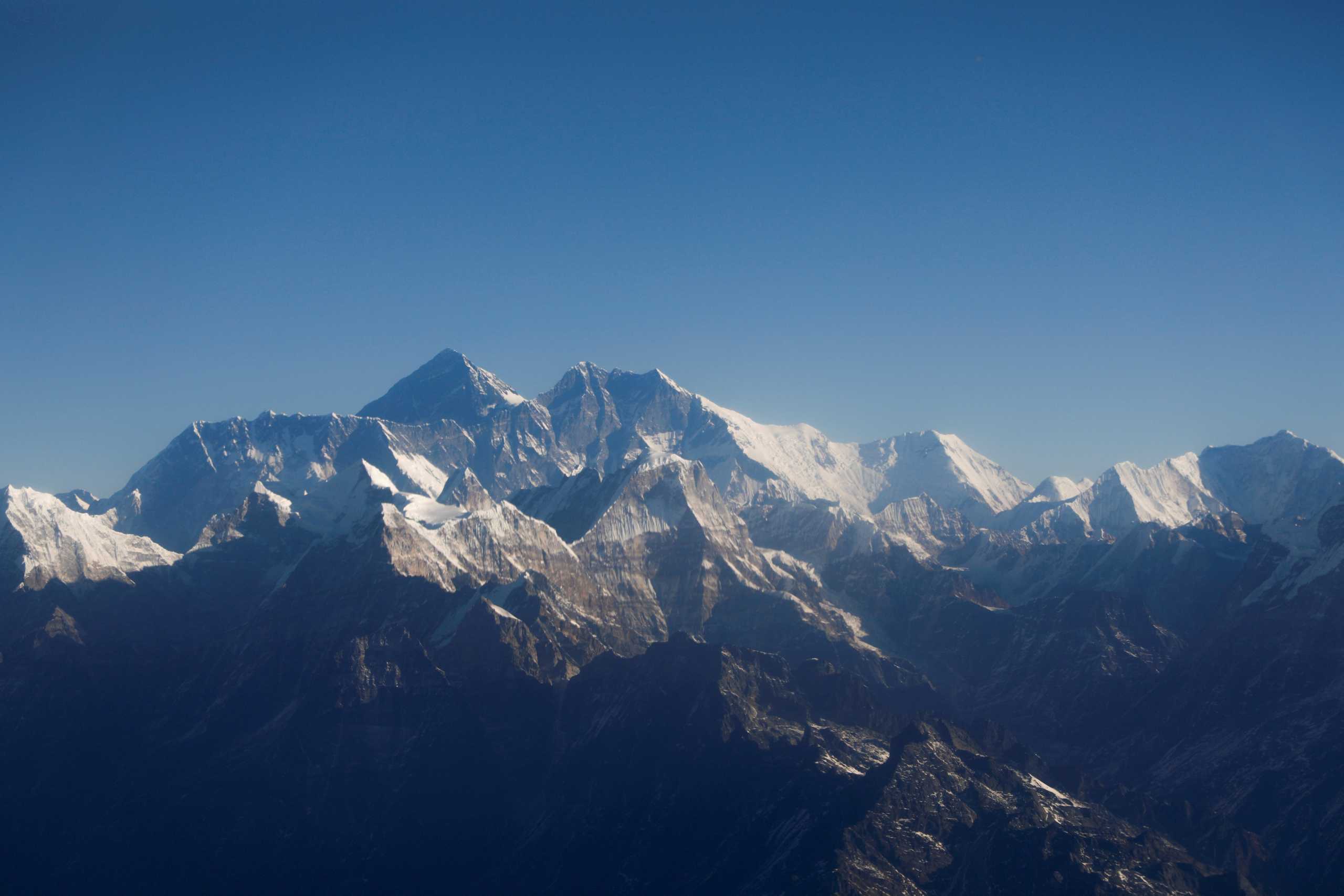 FILE PHOTO: FILE PHOTO: Mount Everest, the world highest peak, and other peaks of the Himalayan range are seen through an aircraft window during a mountain flight from Kathmandu, Nepal January 15, 2020. REUTERS