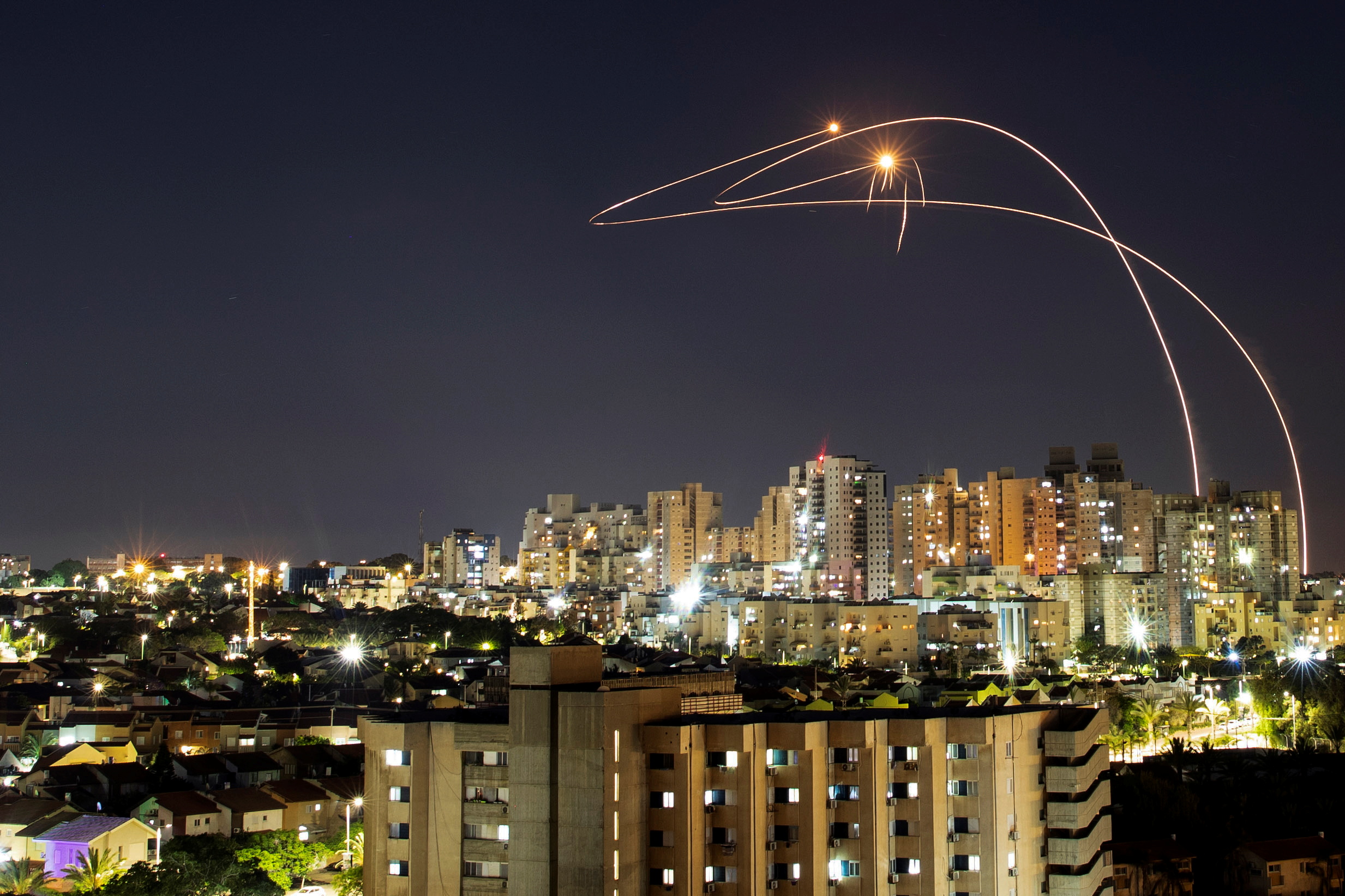 Streaks of light are seen as Israel's Iron Dome anti-missile system intercepts rockets launched from the Gaza Strip towards Israel, as seen from Ashkelon, Israel May 14, 2021. REUTERS