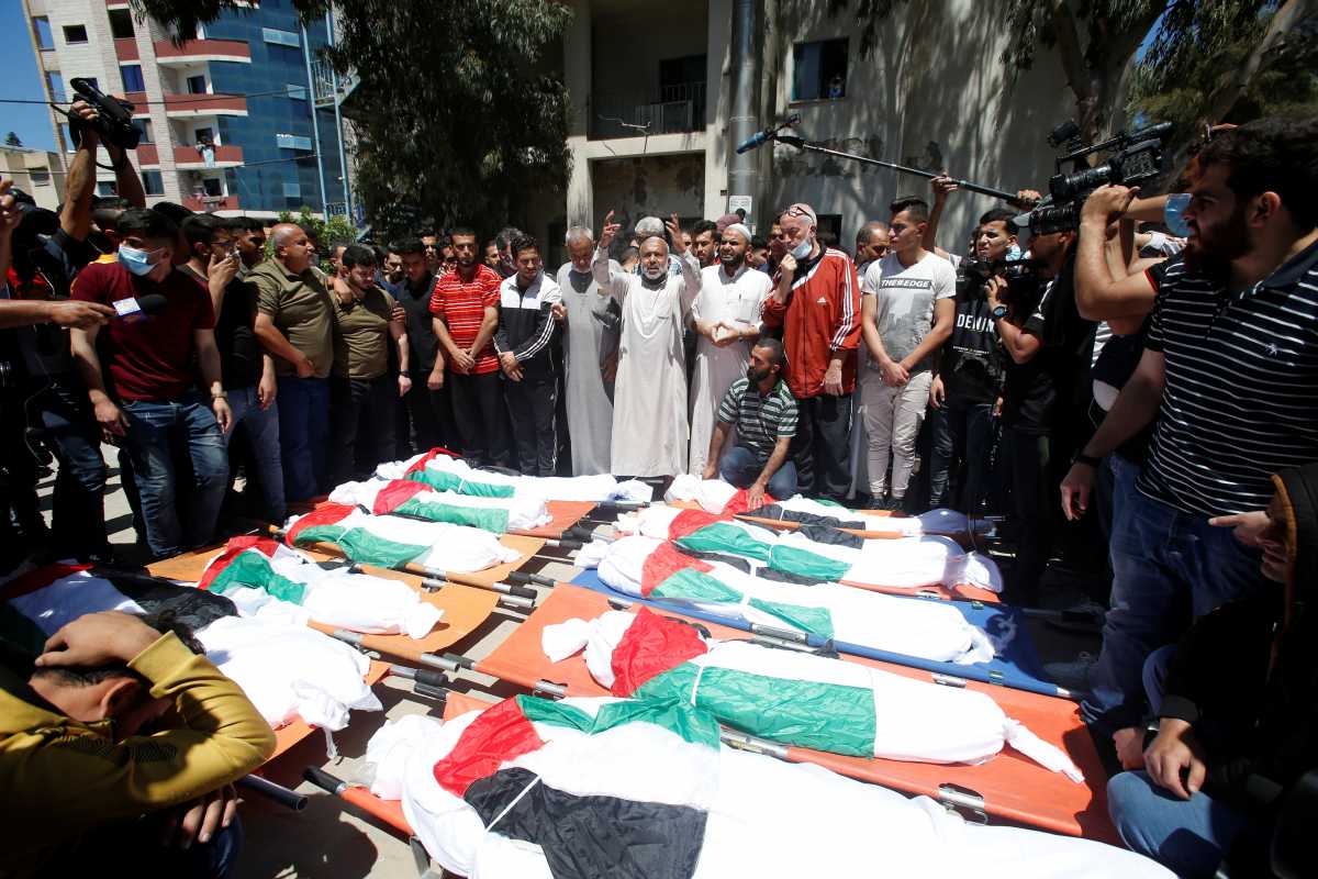Mourners react next to bodies of Palestinians who were killed amid a flare-up of Israeli-Palestinian violence, during their funeral at the Beach refugee camp, in Gaza City May 15, 2021. REUTERS