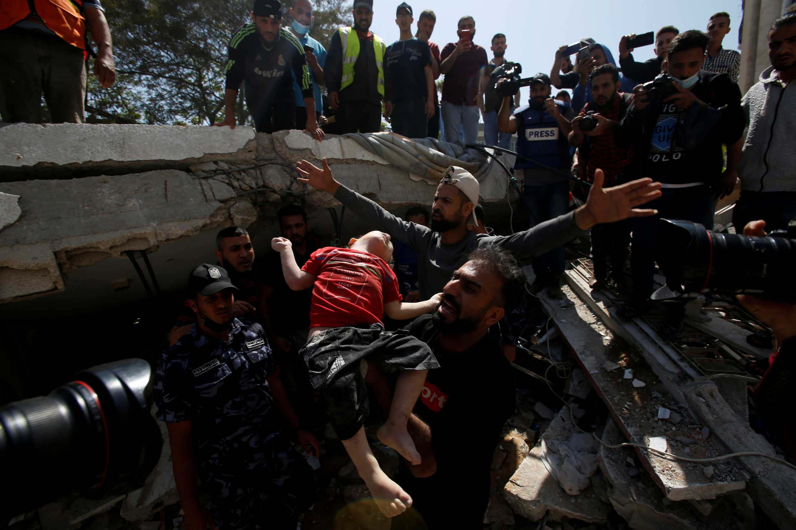 SENSITIVE MATERIAL. THIS IMAGE MAY OFFEND OR DISTURB  People recover the body of a dead Palestinian girl from the rubble of a house that local medics said was hit by Israeli air strikes in Gaza City May 16, 2021. REUTERS