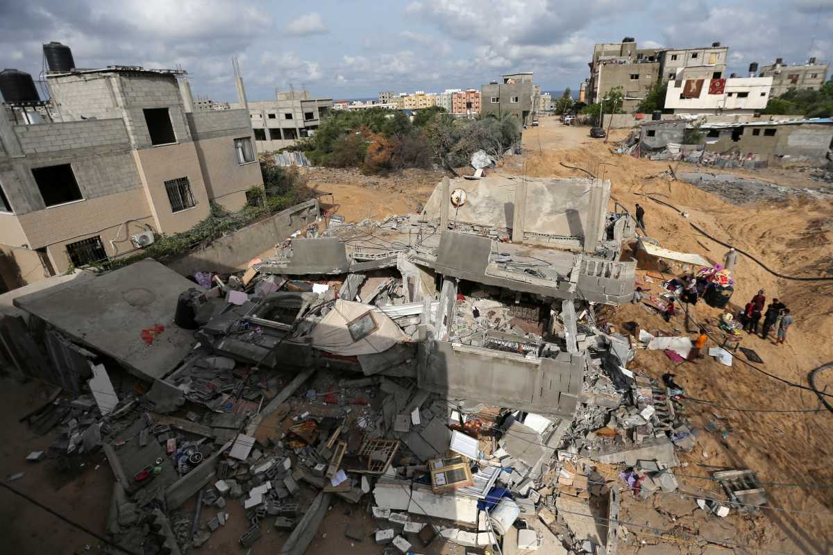 Palestinians gather after returning to their houses which were destroyed by Israeli strikes in the recent cross-border violence between Palestinian militants and Israel, following Israel-Hamas truce, in Gaza May 21, 2021. REUTERS