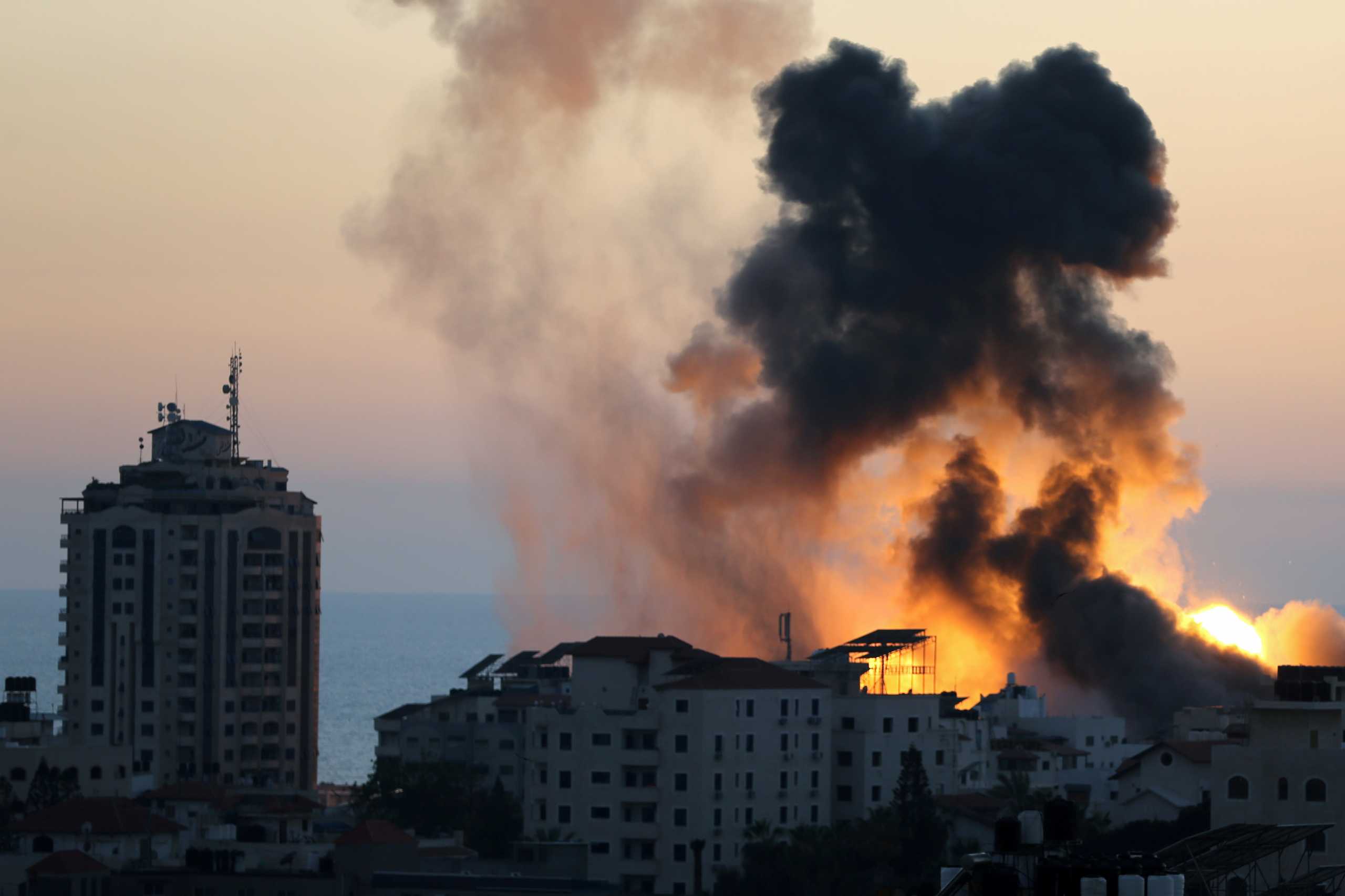 Smoke and flame rise during Israeli air strikes, as cross-border violence between the Israeli military and Palestinian militants continues, in Gaza City, May 14, 2021. REUTERS