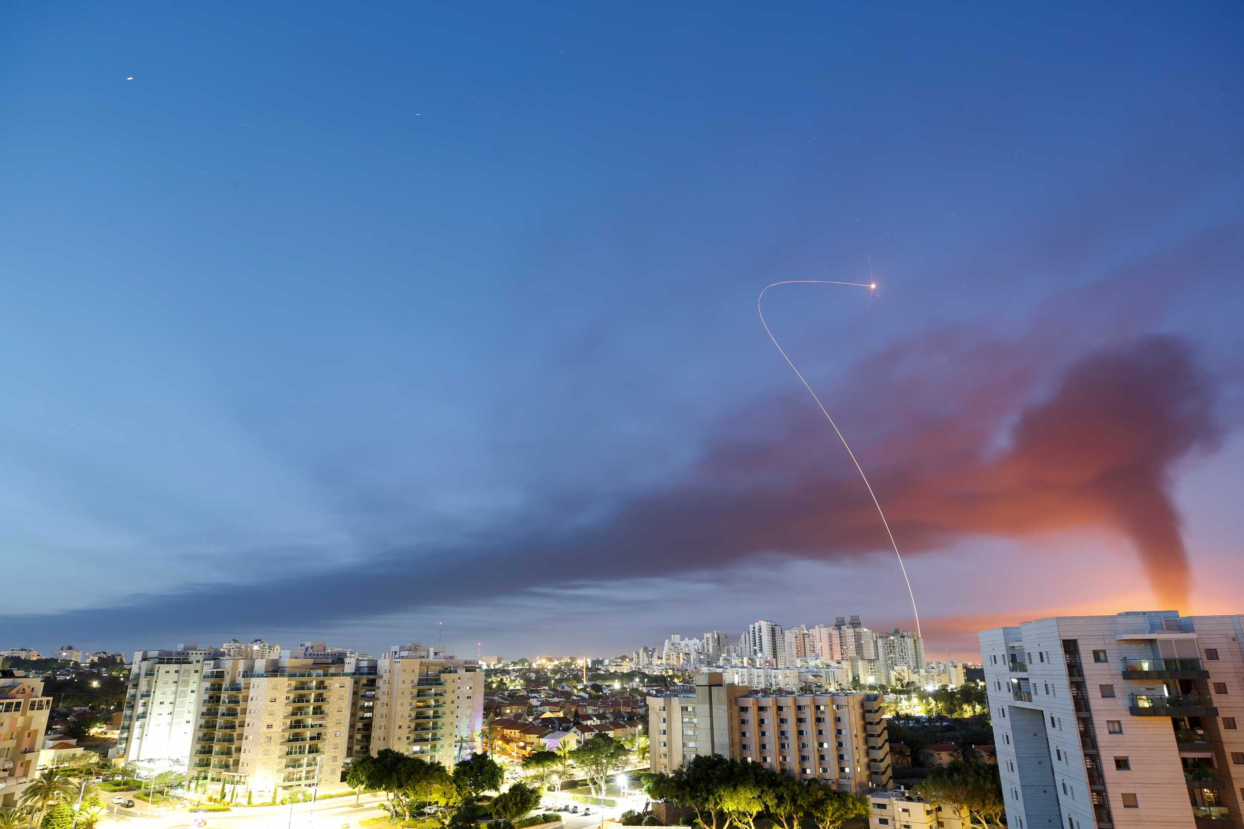 A streak of light is seen as Israel's Iron Dome anti-missile system intercepts rockets launched from the Gaza Strip towards Israel, as seen from Ashkelon, Israel May 12, 2021. REUTERS