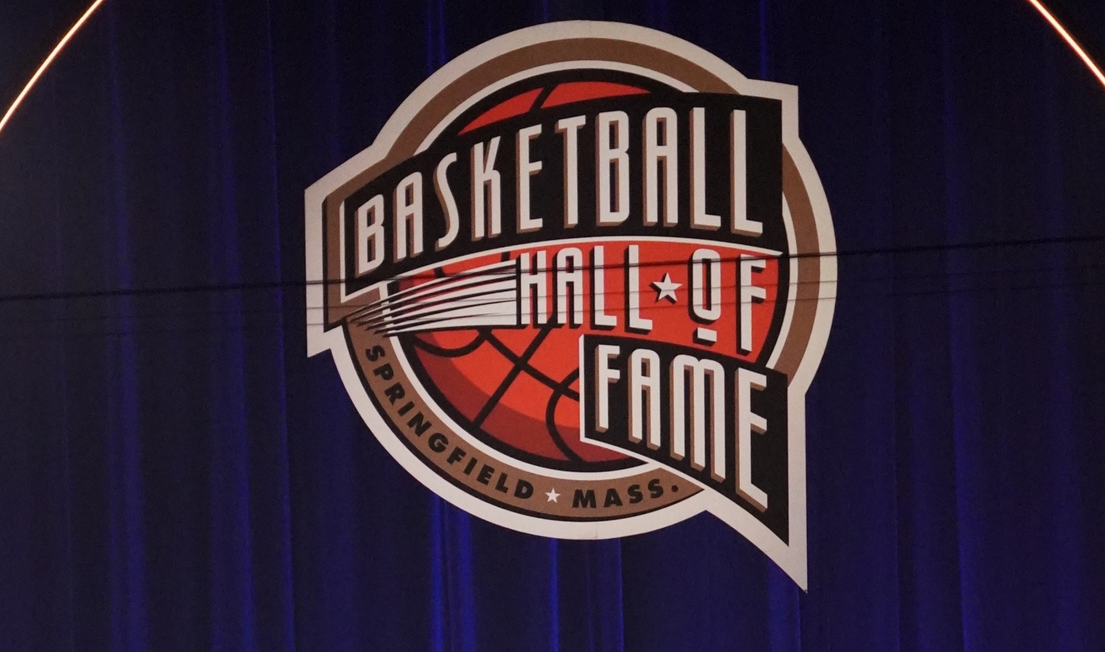 May 15, 2021; Uncasville, Connecticut, USA;  Class of 2020 inductee Rudy Tomjanovich with Calvin Murphy and Hakeem Olajuwon (left), speaks during the Naismith Memorial Basketball Hall of Fame Enshrinement ceremony at Mohegan Sun Arena. Mandatory Credit: David Butler II-USA TODAY Sports