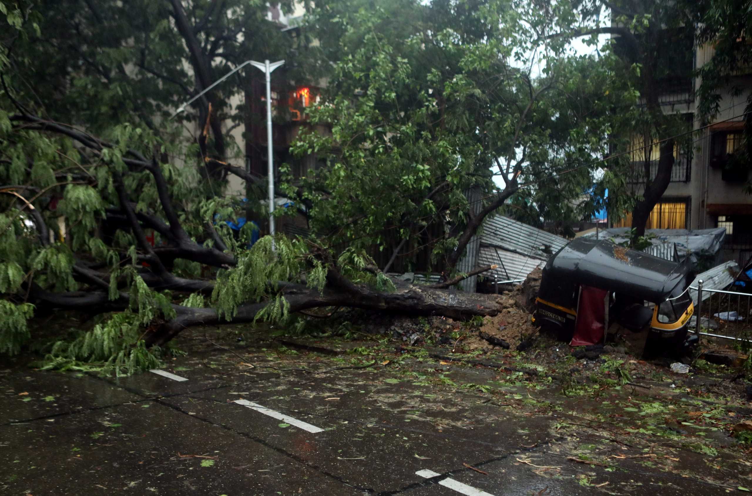 An uprooted tree is seen on a road after strong winds caused by Cyclone Tauktae in Mumbai, India May 17, 2021. REUTERS