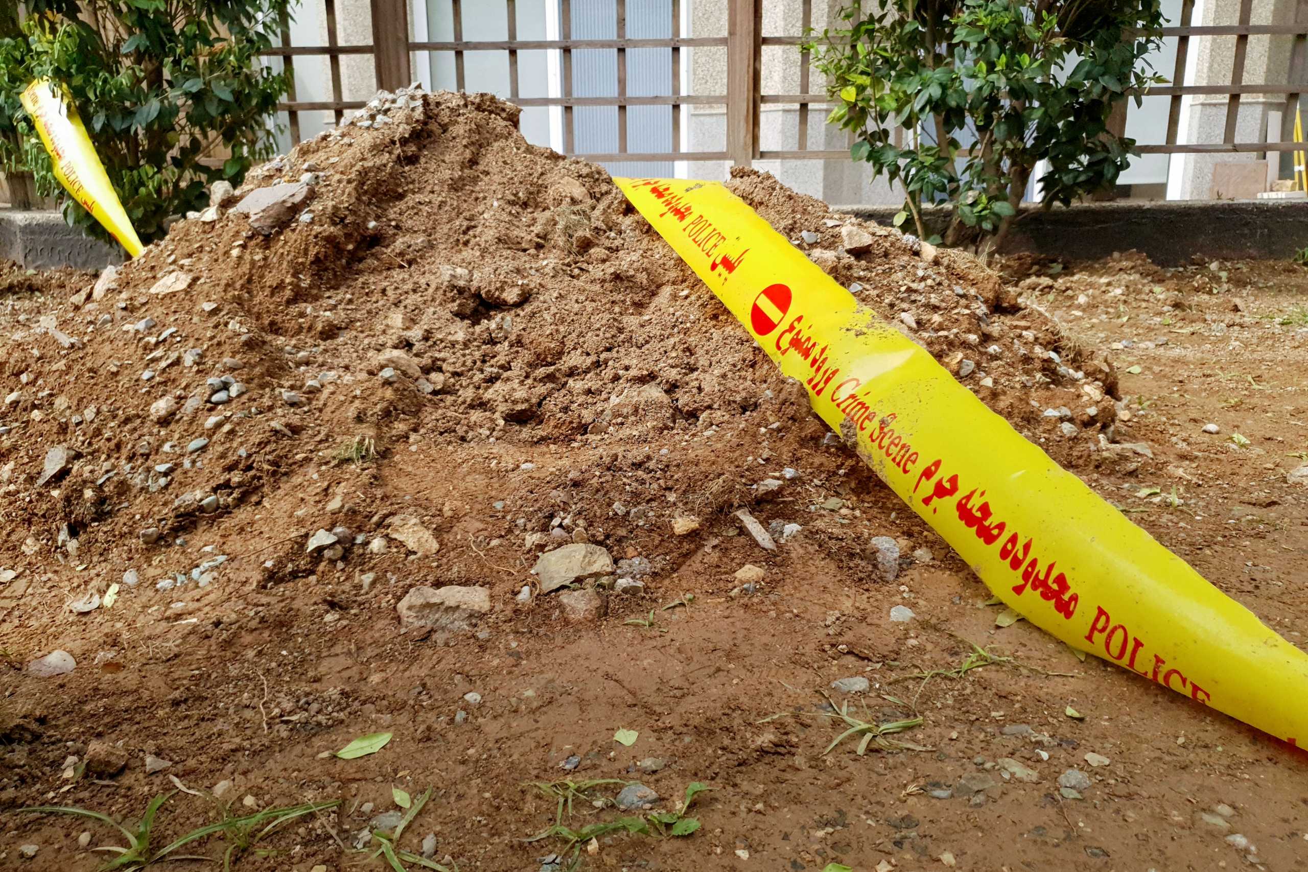 A cordon tape is seen at the garden in front of the tower, where the body of the Swiss embassy's first secretary was found after falling from a building, in Tehran, Iran May 4, 2021. Naser Safarzadeh