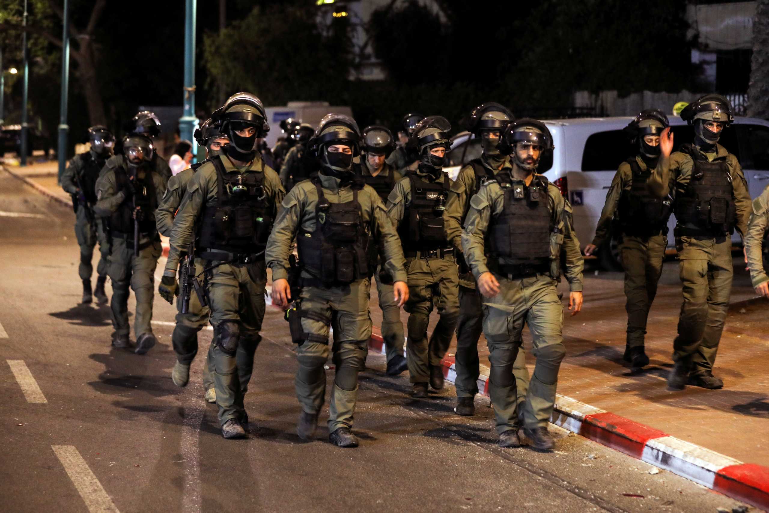 Israeli security force members patrol during a night-time curfew following violence in the Arab-Jewish town of Lod, Israel May 12, 2021. REUTERS