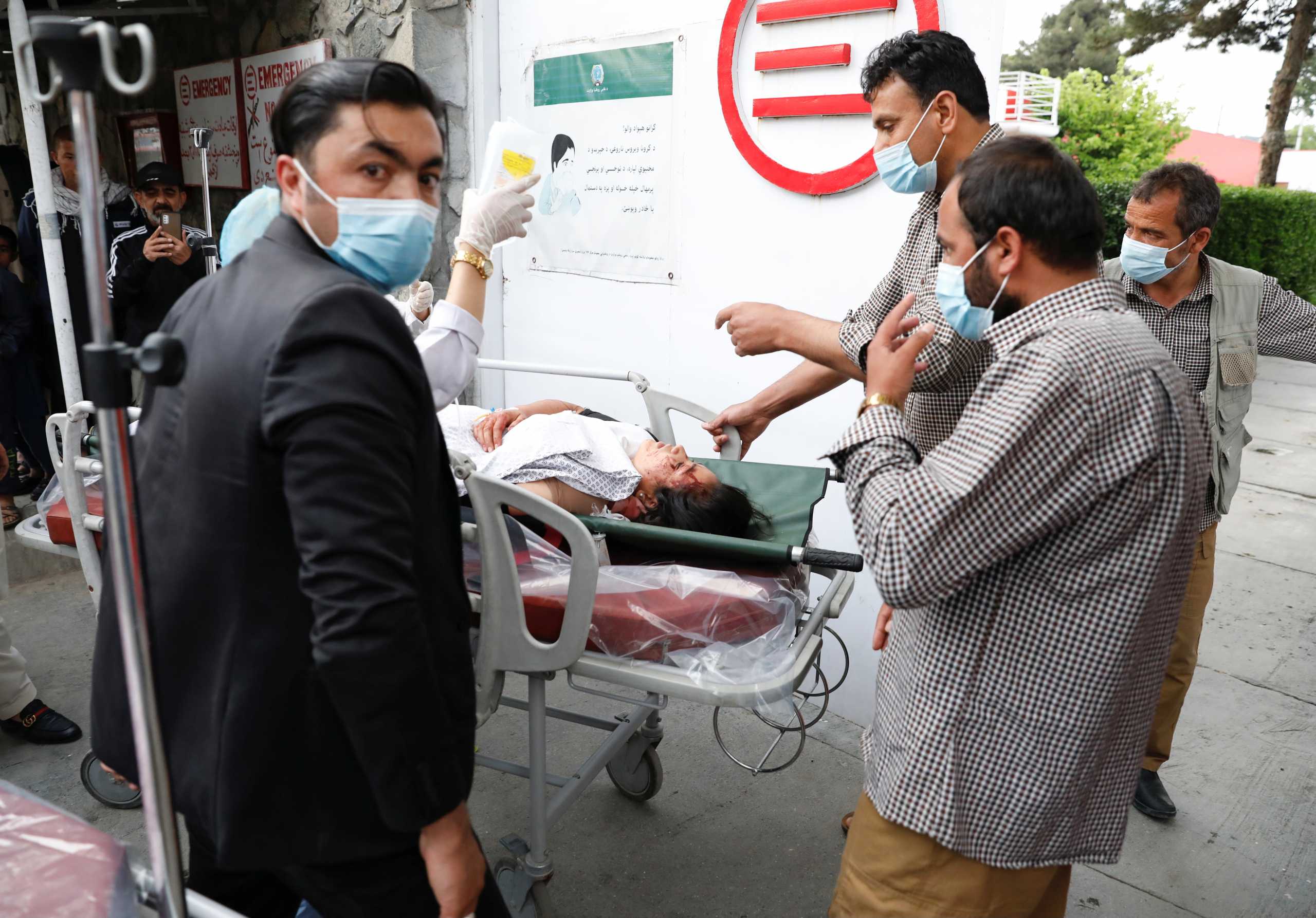 SENSITIVE MATERIAL. THIS IMAGE MAY OFFEND OR DISTURB    People transport an injured woman to a hospital after a blast in Kabul, Afghanistan May 8, 2021. REUTERS