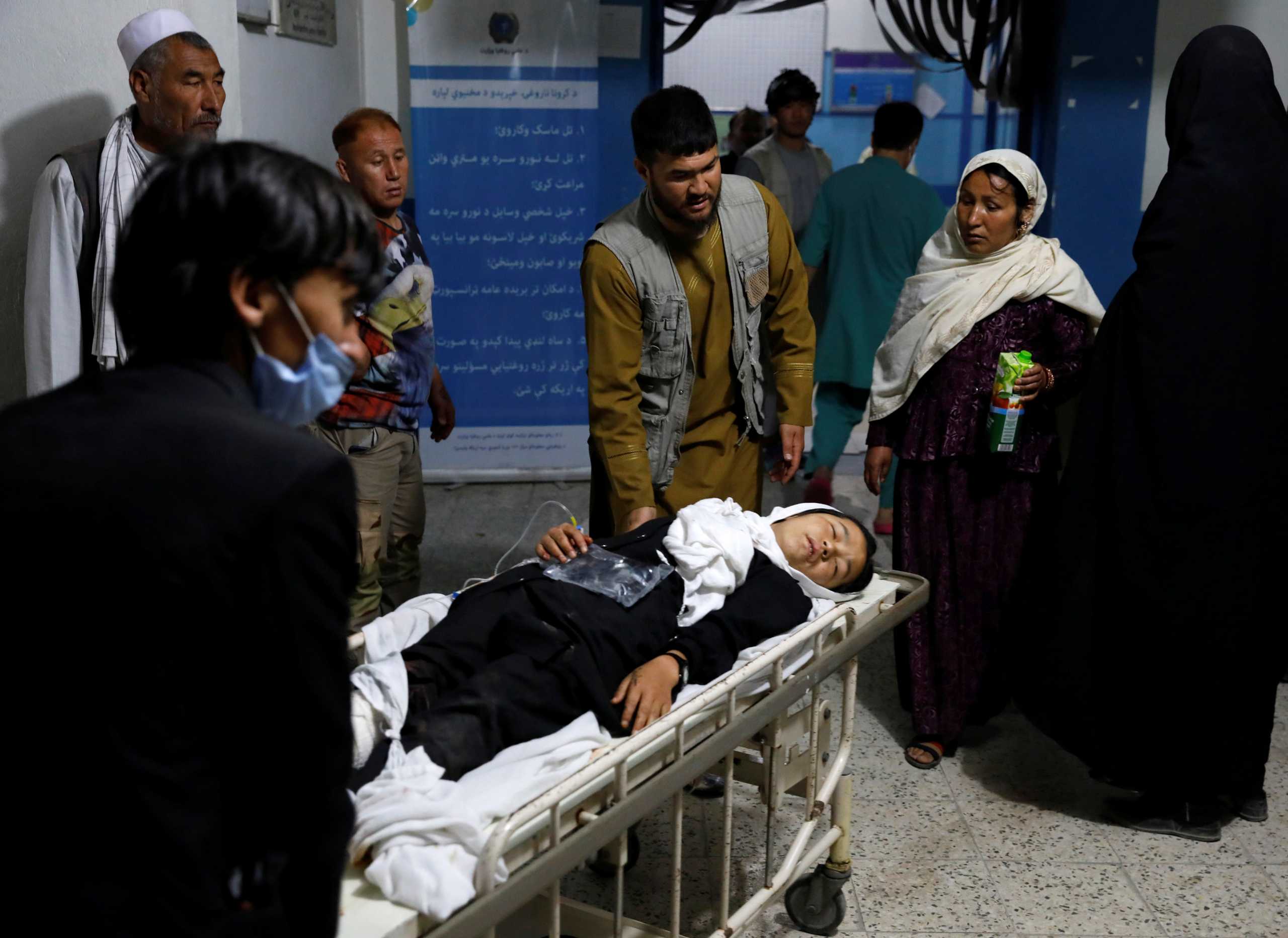 An injured school girl is transported to a hospital after a blast in Kabul, Afghanistan May 8, 2021. REUTERS