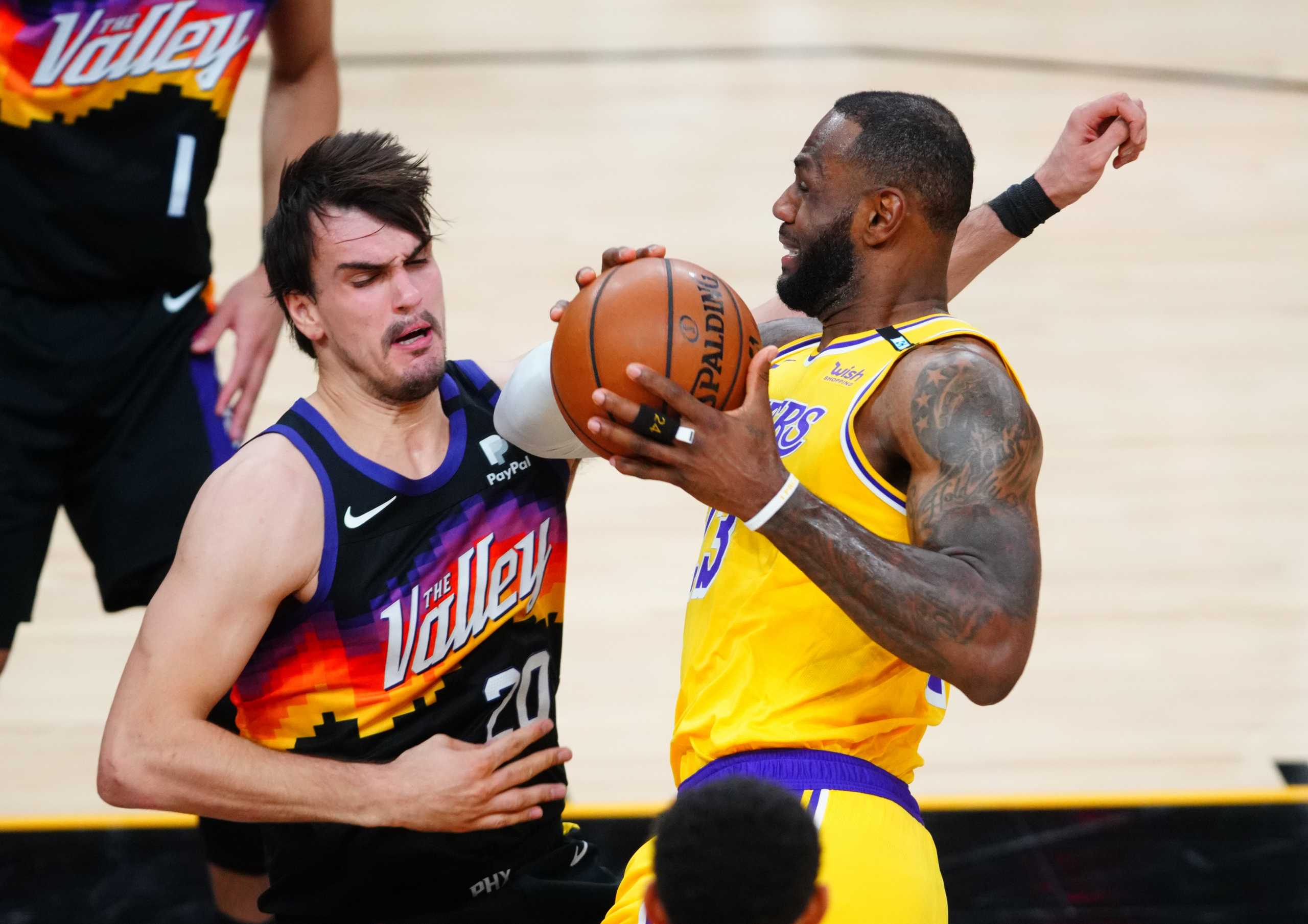 May 25, 2021; Phoenix, Arizona, USA; Los Angeles Lakers forward LeBron James (right) drives to the basket against Phoenix Suns forward Dario Saric during the first half in game two of the first round of the 2021 NBA Playoffs at Phoenix Suns Arena. Mandatory Credit: Mark J. Rebilas-USA TODAY Sports