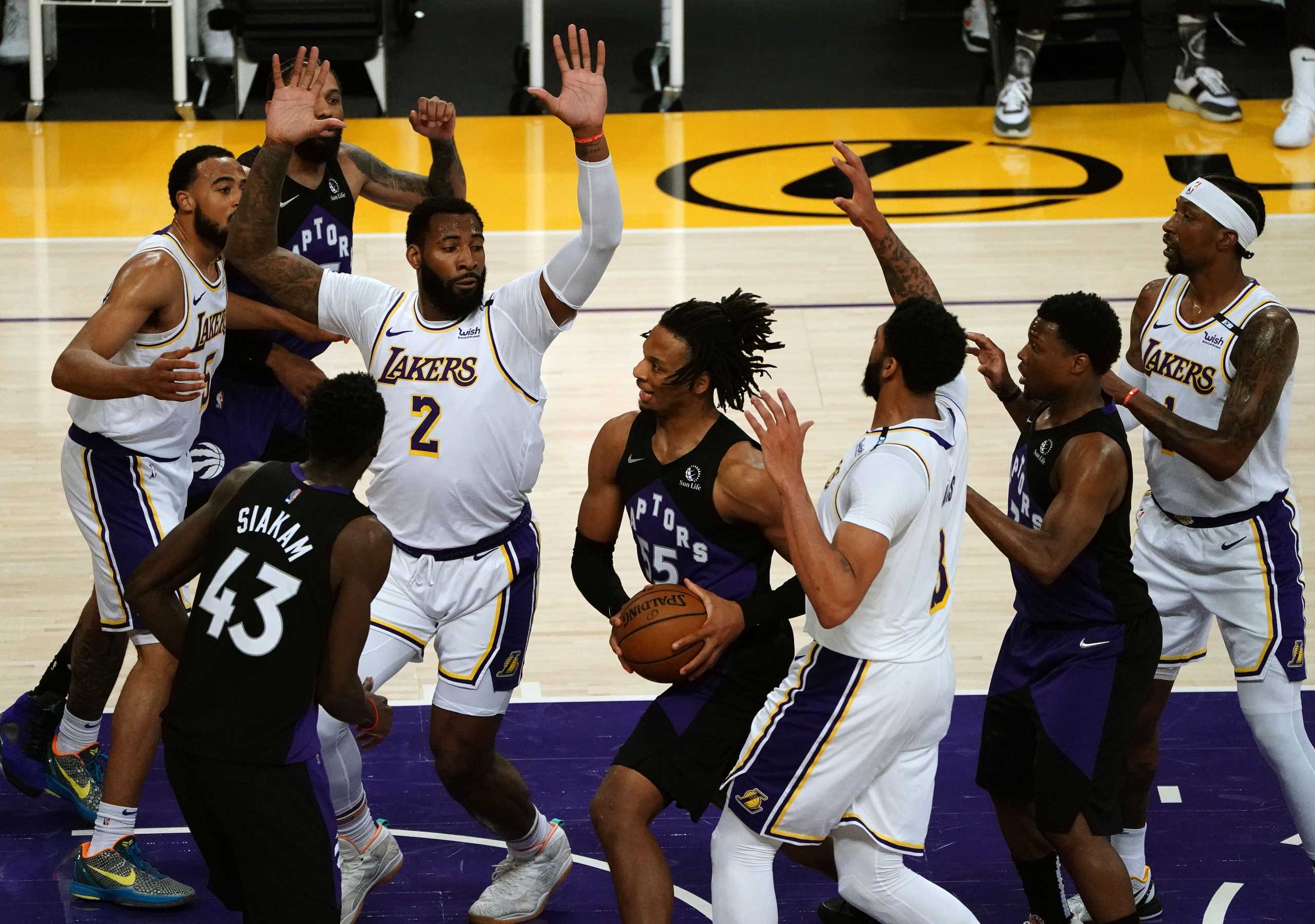 May 2, 2021; Los Angeles, California, USA; Toronto Raptors forward Freddie Gillespie (55) moves to the basket against Los Angeles Lakers center Andre Drummond (2) and forward Anthony Davis (3) during the second half at Staples Center. Mandatory Credit: Gary A. Vasquez-USA TODAY Sports