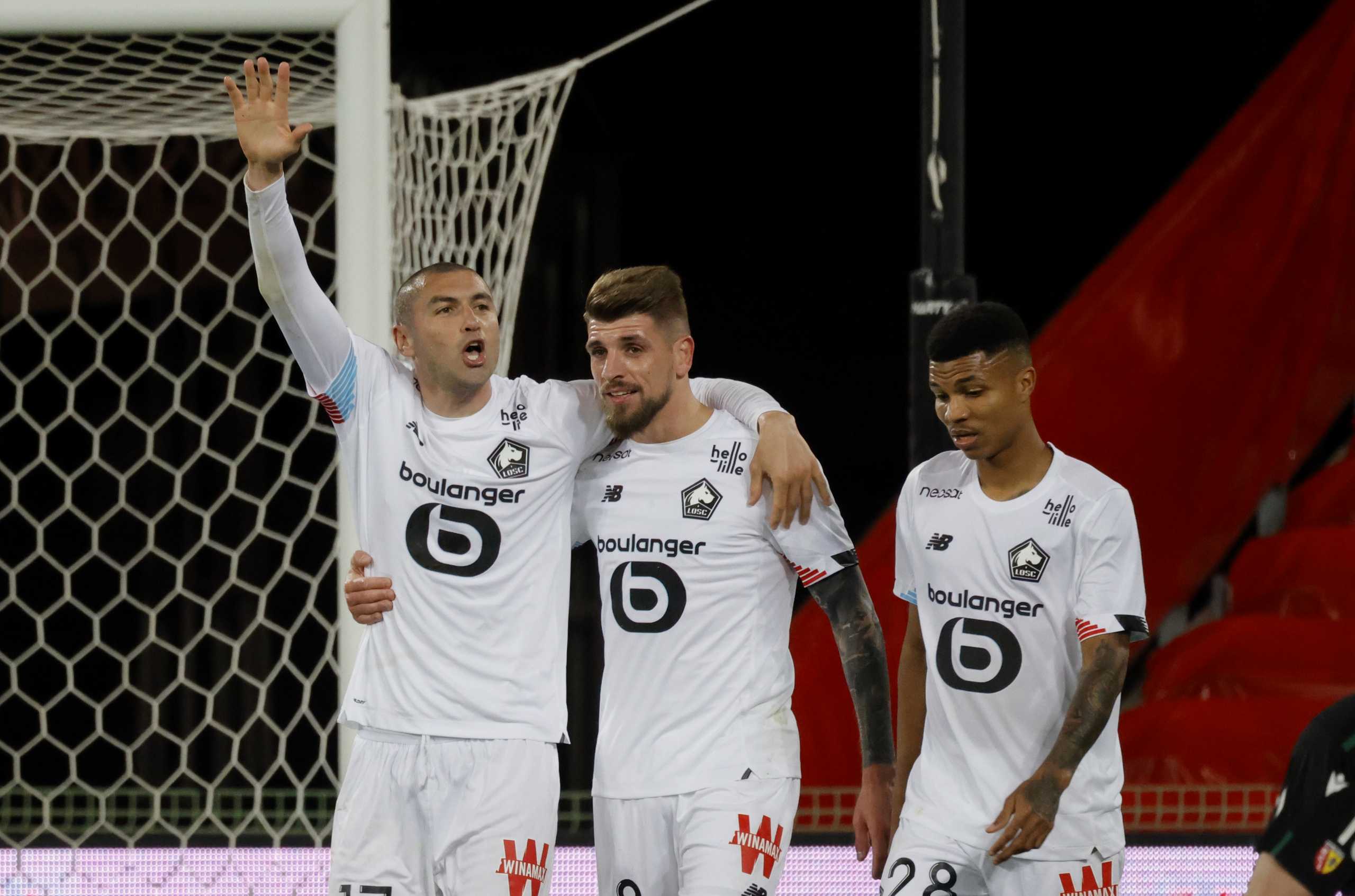 Soccer Football - Ligue 1 - RC Lens v Lille - Stade Bollaert-Delelis, Lens, France - May 7, 2021 Lille's Burak Yilmaz celebrates scoring their second goal with teammates REUTERS