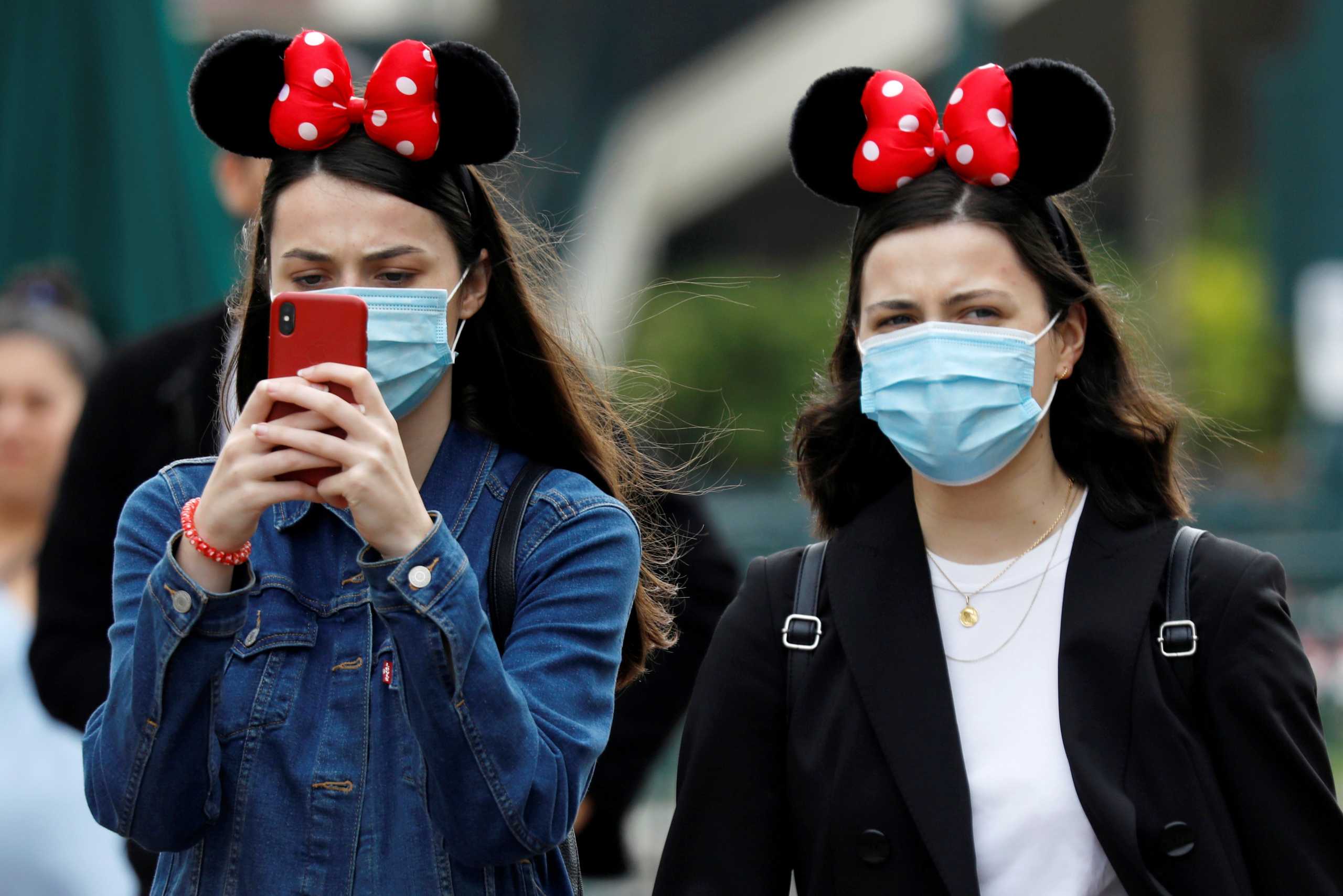 FILE PHOTO: Visitors wear protective face masks at Disneyland Paris, July 15, 2020.   REUTERS