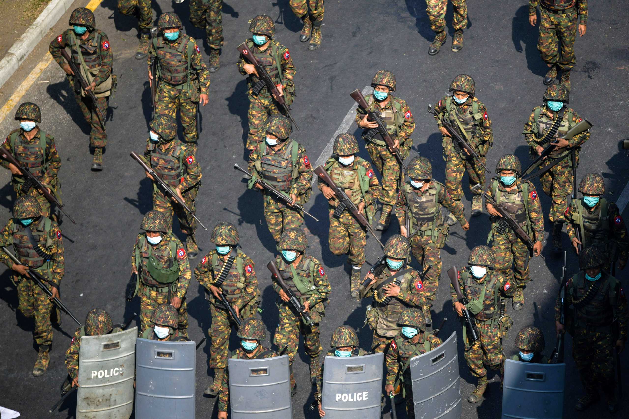 FILE PHOTO: Myanmar soldiers walk along a street during a protest against the military coup in Yangon, Myanmar, February 28, 2021. REUTERS