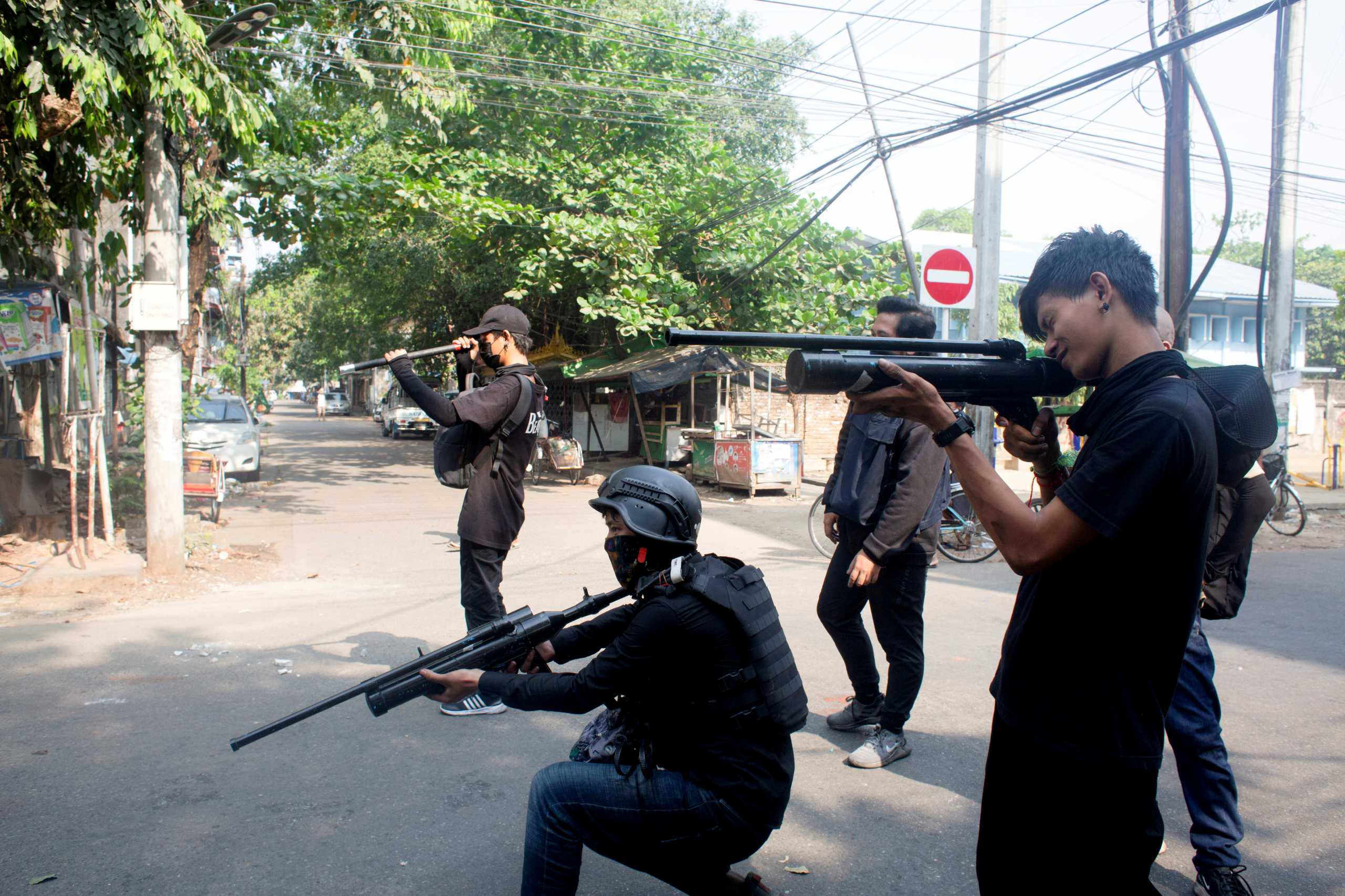 FILE PHOTO: Protesters hold homemade pipe air guns during a protest against the military coup in Yangon, Myanmar April 3, 2021. REUTERS