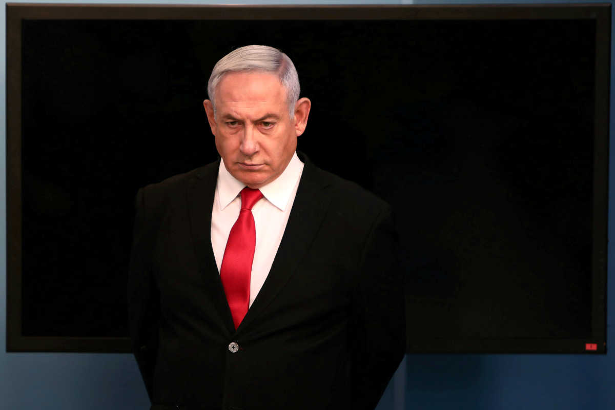 FILE PHOTO: Israeli Prime Minister Benjamin Netanyahu arrives for a speech at his Jerusalem office, regarding the new measures that will be taken to fight the coronavirus, March 14, 2020. Gali Tibbon