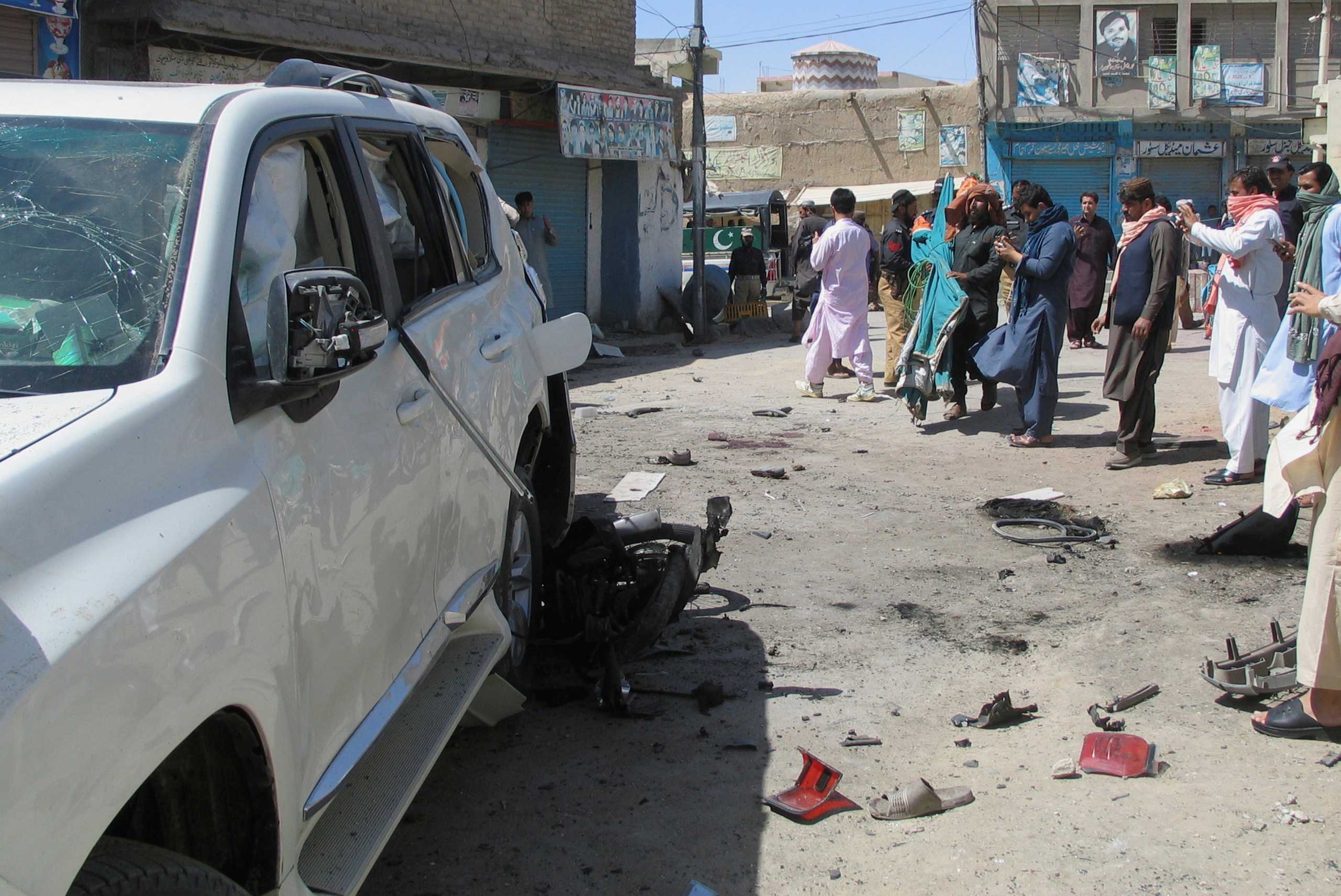 Police and residents gather at the site after a bomb blast in the Pakistan-Afghanistan border town of Chaman, Pakistan, May 21, 2021. REUTERS