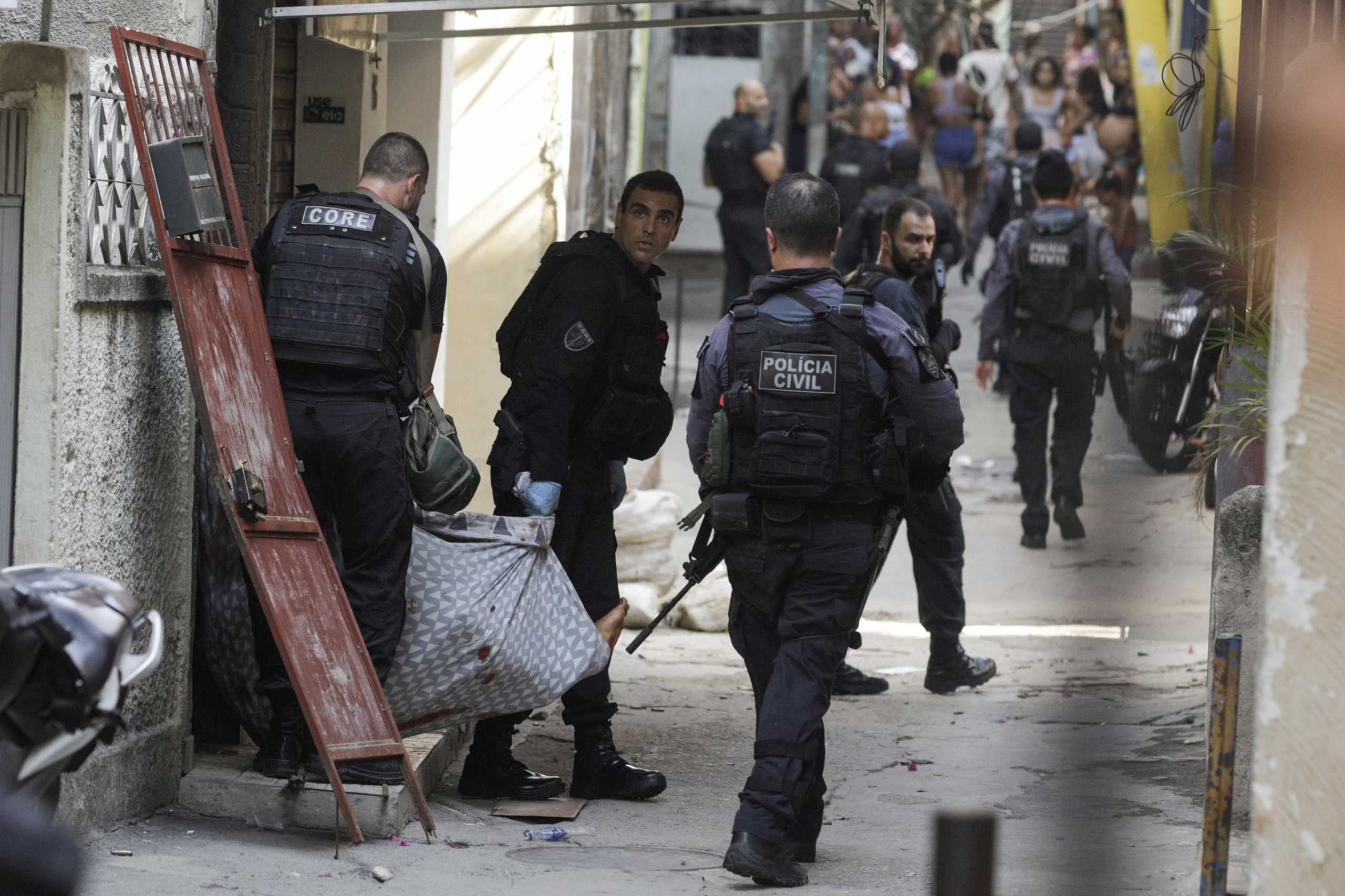 SENSITIVE MATERIAL. THIS IMAGE MAY OFFEND OR DISTURB Policemen carry a wounded suspect during an operation against drug dealers in Jacarezinho slum in Rio de Janeiro, Brazil May 6, 2021. REUTERS