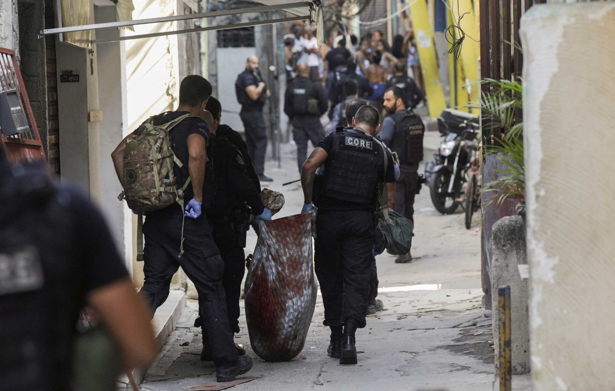 SENSITIVE MATERIAL. THIS IMAGE MAY OFFEND OR DISTURB Policemen carry a wounded suspect during an operation against drug dealers in Jacarezinho slum in Rio de Janeiro, Brazil May 6, 2021. REUTERS