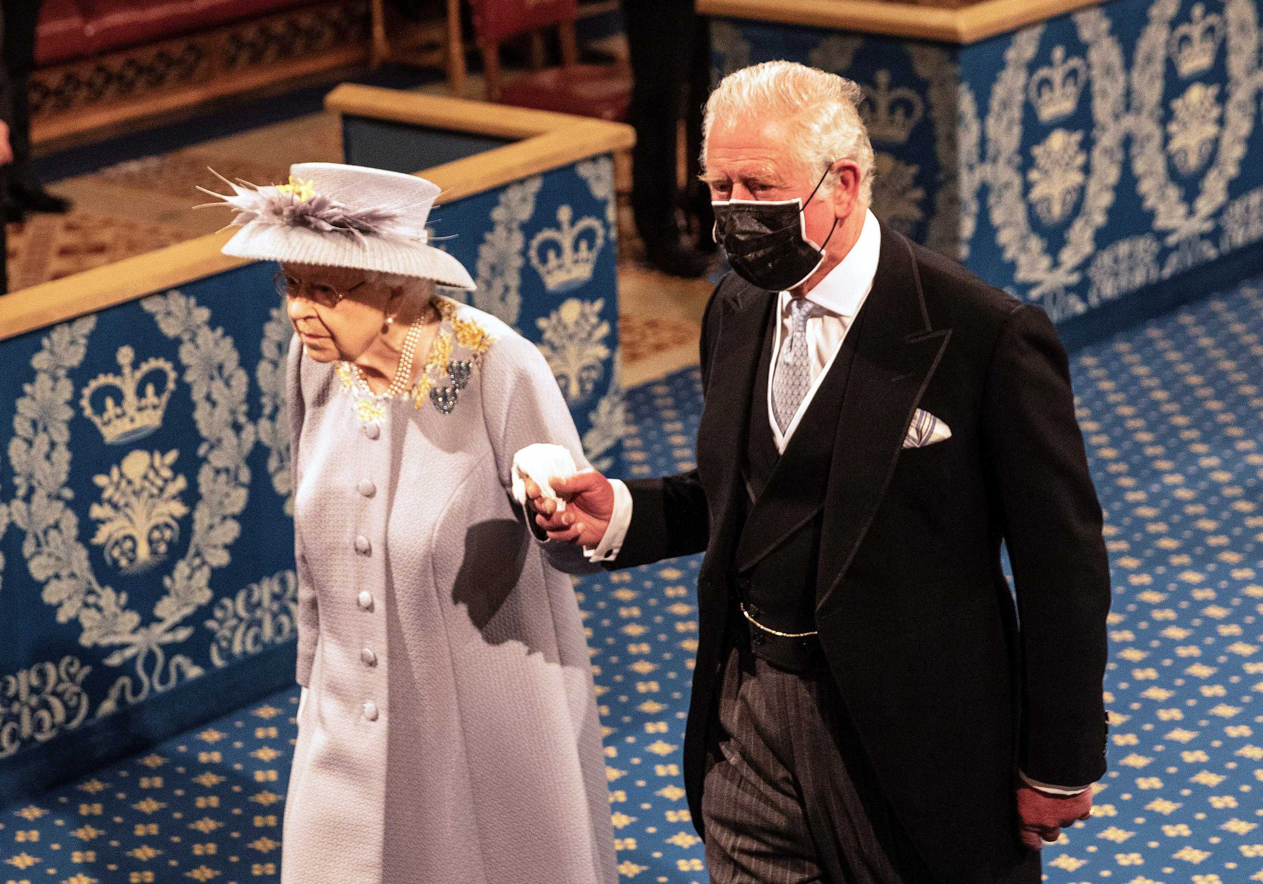 Britain's Queen Elizabeth processes down the Royal gallery led by the imperial state crown and escorted by Prince Charles during the State Opening of Parliament in London, Britain May 11, 2021. Richard Pohle