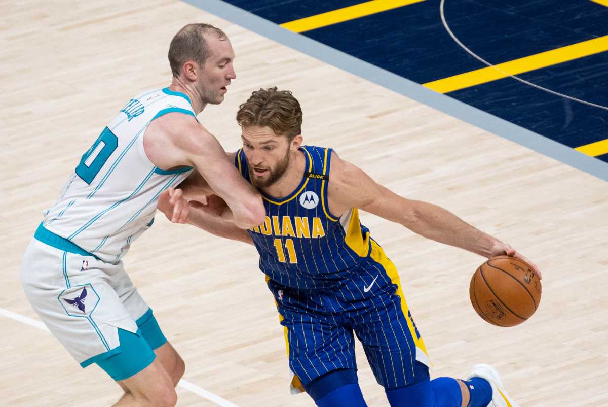 May 18, 2021; Indianapolis, Indiana, USA; Indiana Pacers forward Domantas Sabonis (11) dribbles the ball while Charlotte Hornets center Cody Zeller (40) defends  in the second quarter at Bankers Life Fieldhouse. Mandatory Credit: Trevor Ruszkowski-USA TODAY Sports