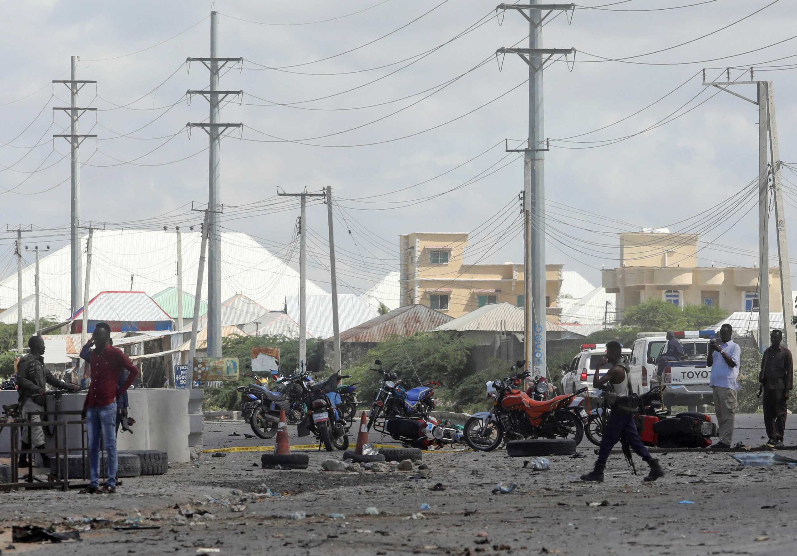 Somalian security officers gather at the scene after suicide car explosion at the Asluubta Prison in Darkenley district of Mogadishu, Somalia April 28, 2021. REUTERS
