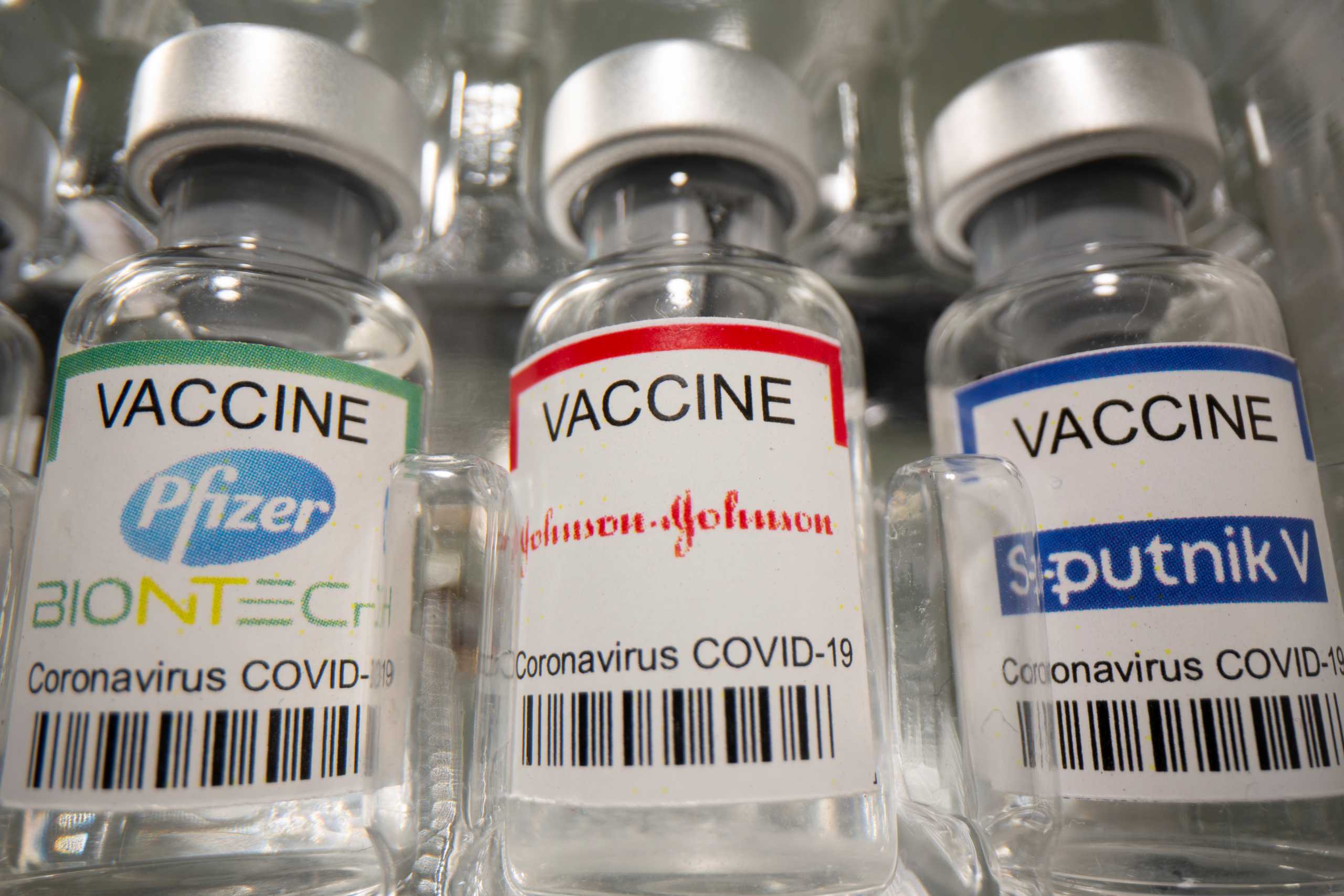 Vials labelled "Pfizer - Biontech, Johnson&Johnson, Sputnik V coronavirus disease (COVID-19) vaccine" are seen in this illustration picture taken May 2, 2021. REUTERS