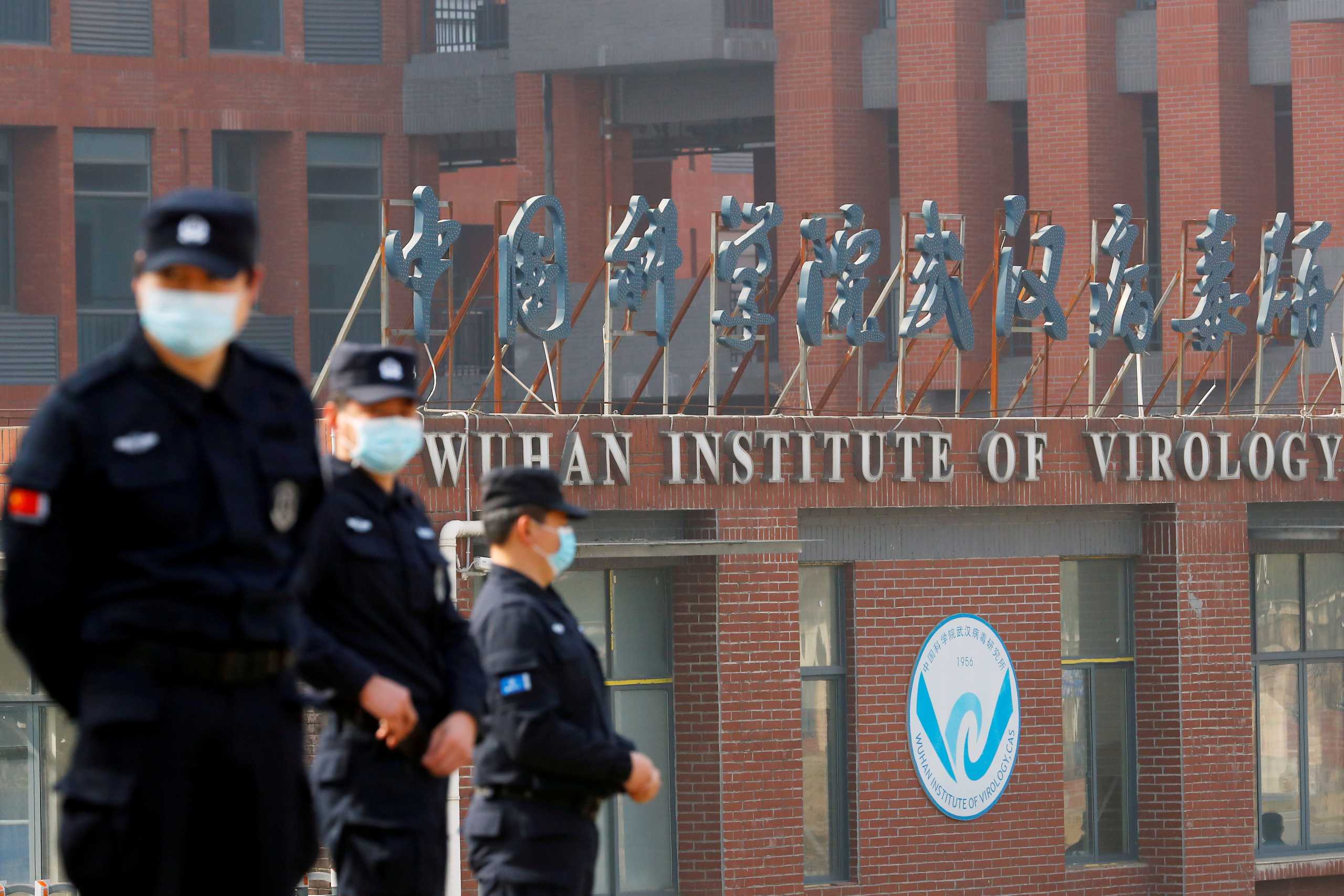 FILE PHOTO: Security personnel keep watch outside the Wuhan Institute of Virology during the visit by the World Health Organization (WHO) team tasked with investigating the origins of the coronavirus disease (COVID-19), in Wuhan, Hubei province, China February 3, 2021. REUTERS
