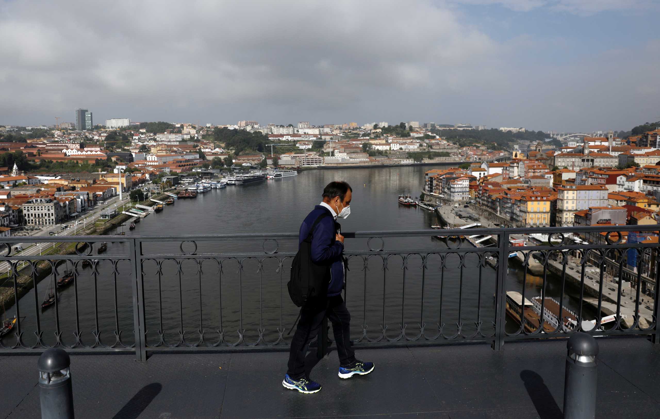 FILE PHOTO: A man walks on Dom Luis I Bridge in Porto ahead of the Champions League Final, May 28, 2021.  REUTERS