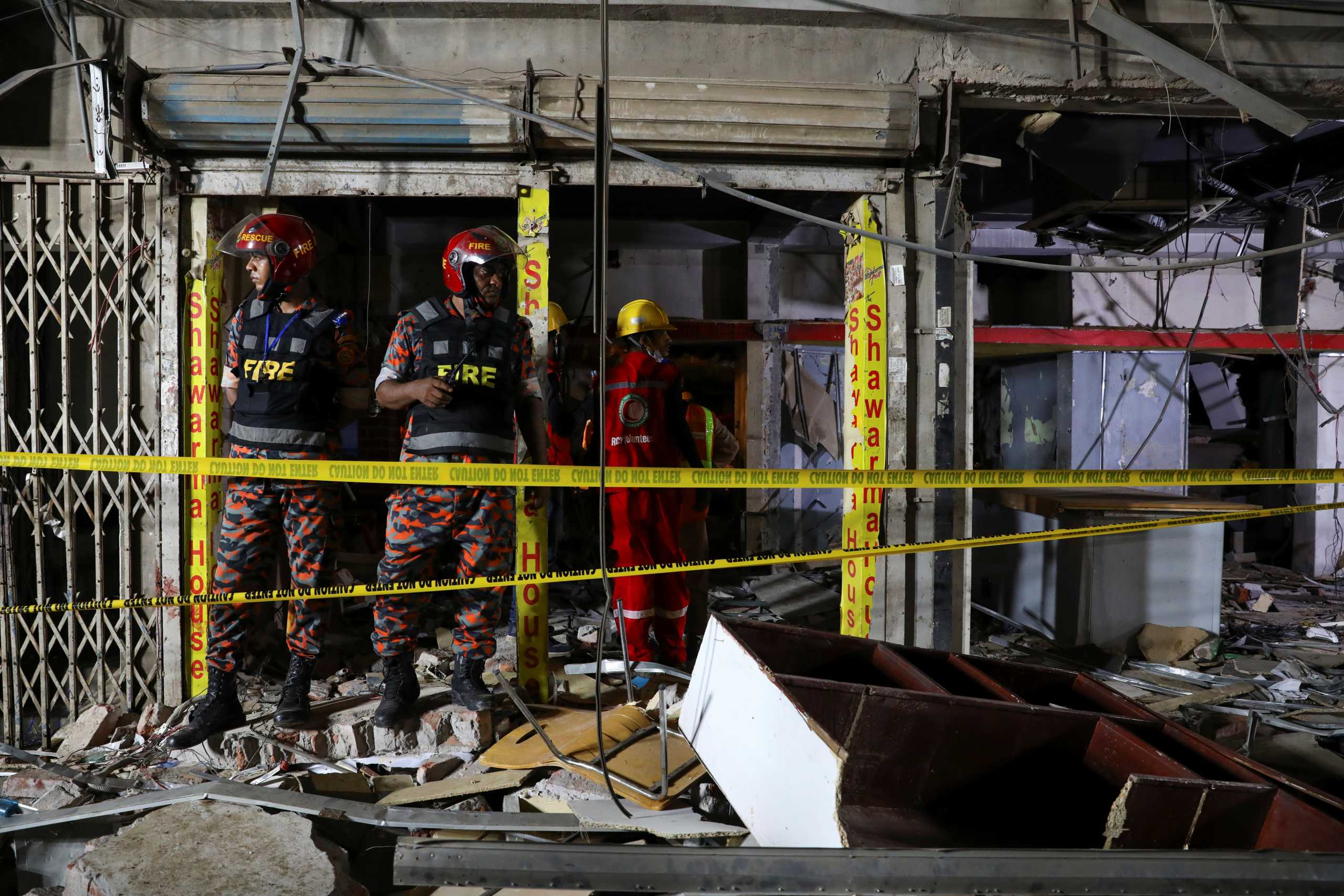 Rescue workers inspect the site after a blast in a shop that killed several people in Dhaka, Bangladesh, June 27, 2021. REUTERS